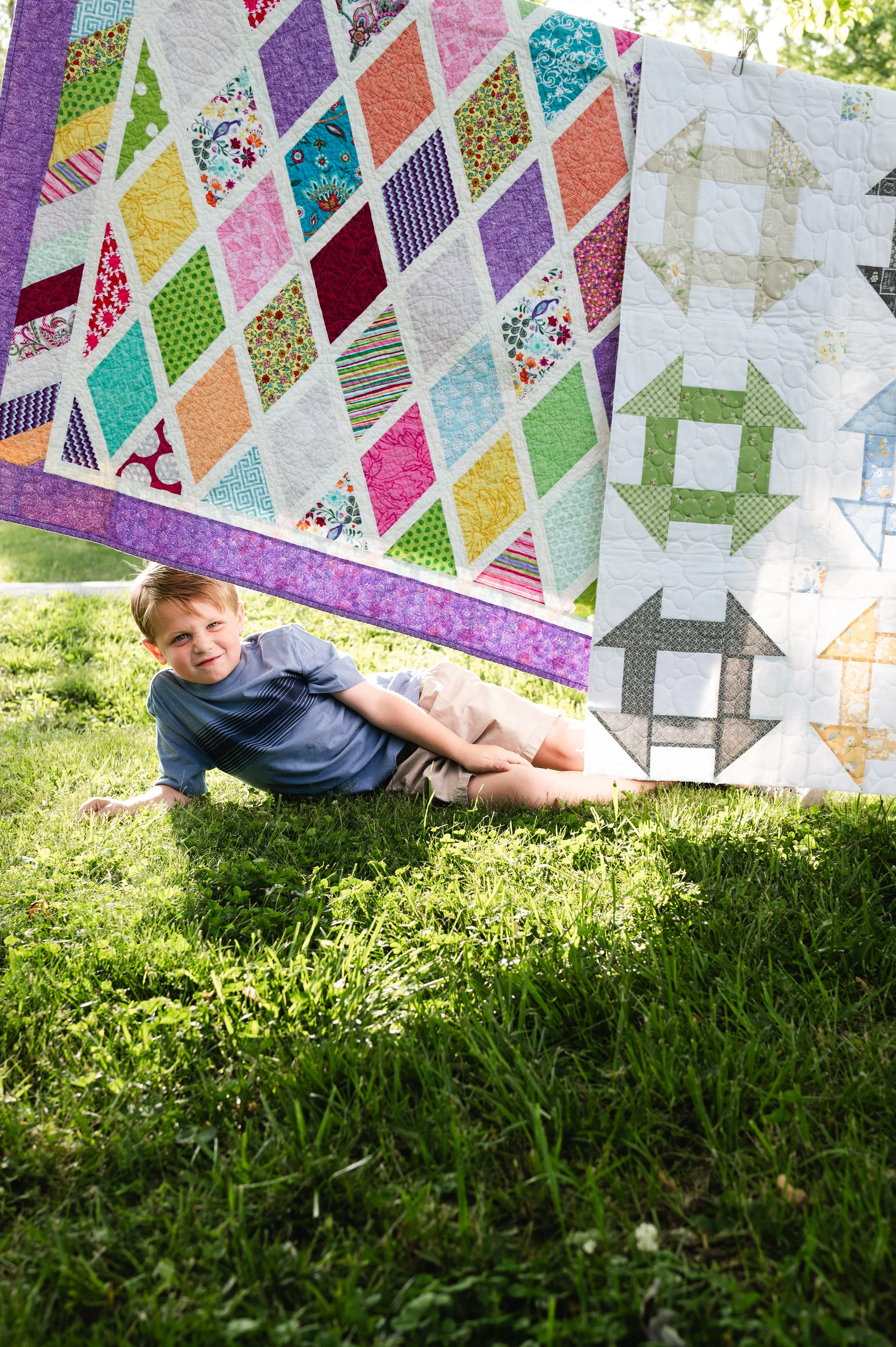 boy with colorful quilts, candid family photos, family photographer, clarksville tn, affordable, nashville tn