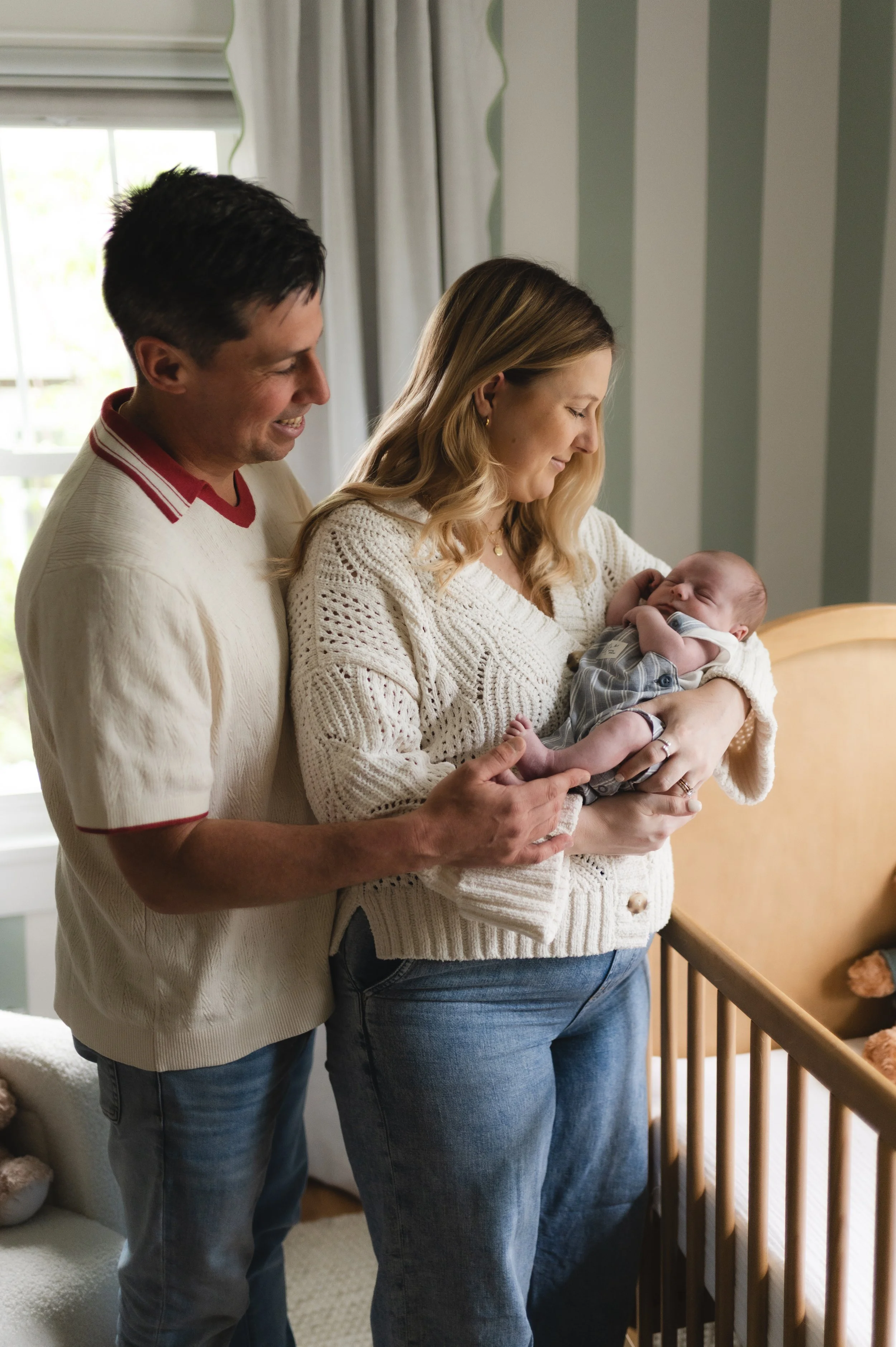 man and woman with newborn baby in nursery, clarksville tn, nashville tn, affordable, newborn photographer