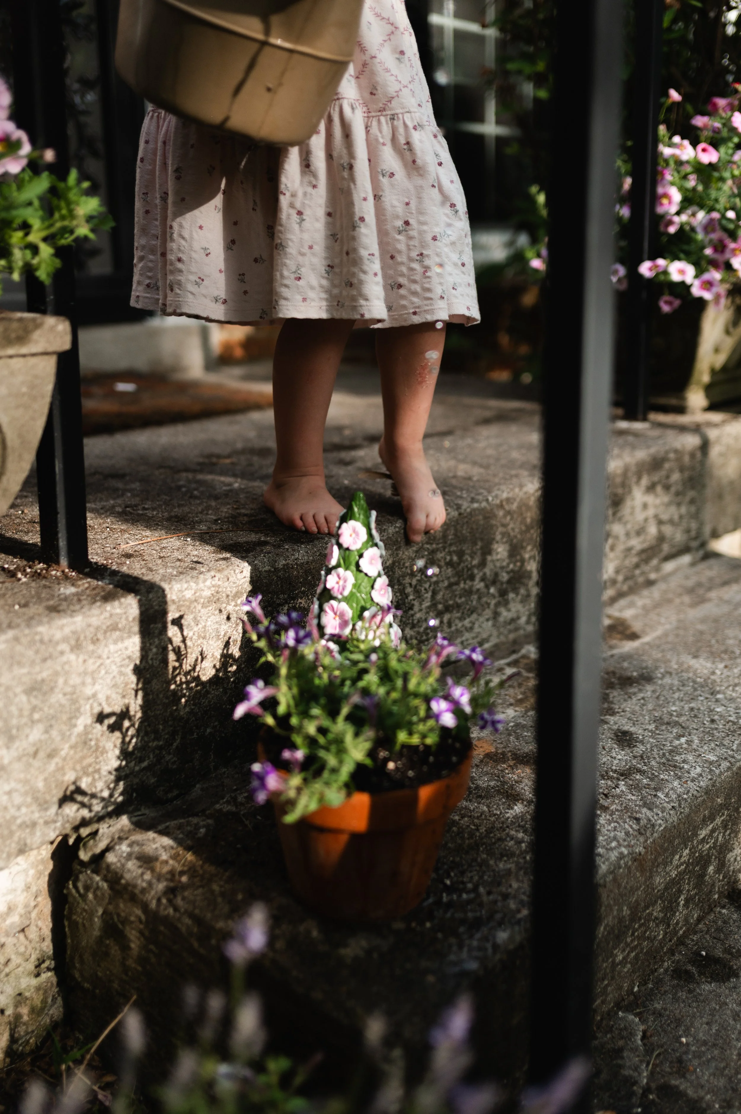 girl watering plants, clarksville tn photographer, nashville tn photographer, affordable, home session, candid family photos