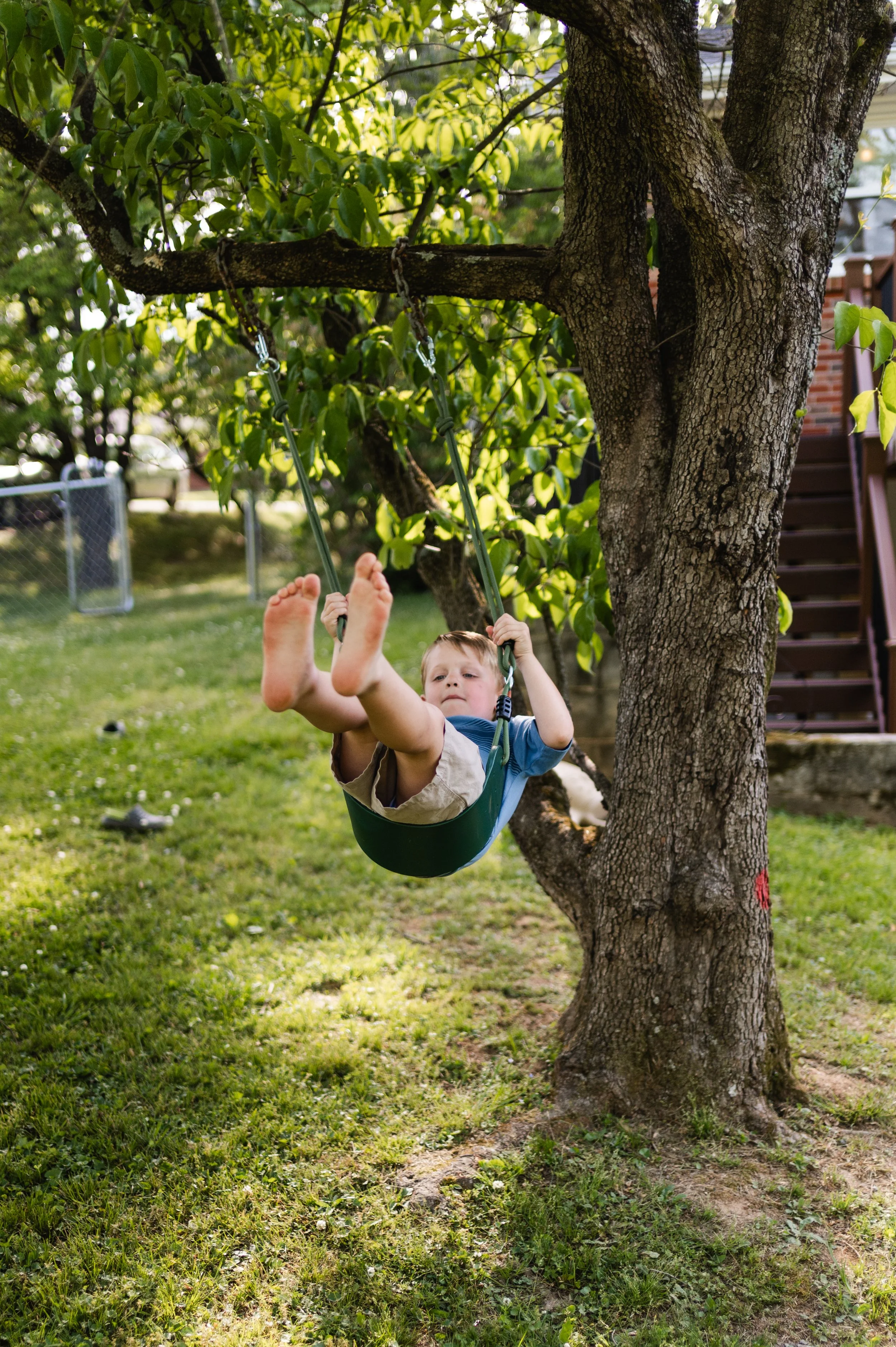 boy on tree swing in yard, storytelling family photos, candid family photos, family photographer, clarksville tn, nashville tn