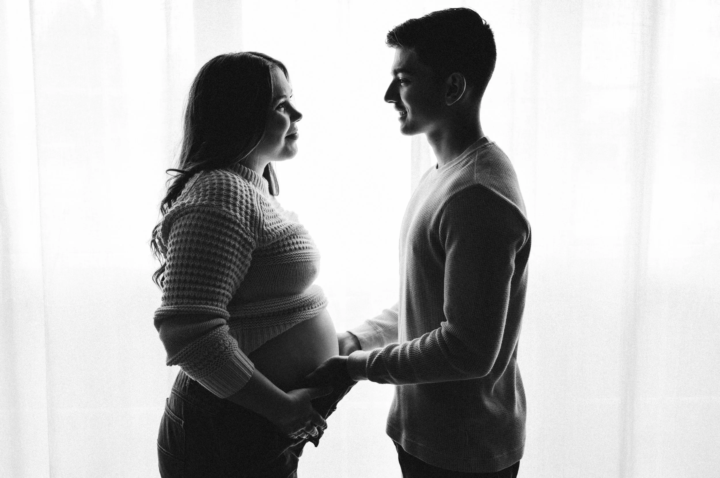 backlit maternity photo of woman and man standing before window, clarksville tn, maternity photographer, newborn photographer, newborn and maternity, nashville tn, affordable, film, lifestyle, in-home maternity session