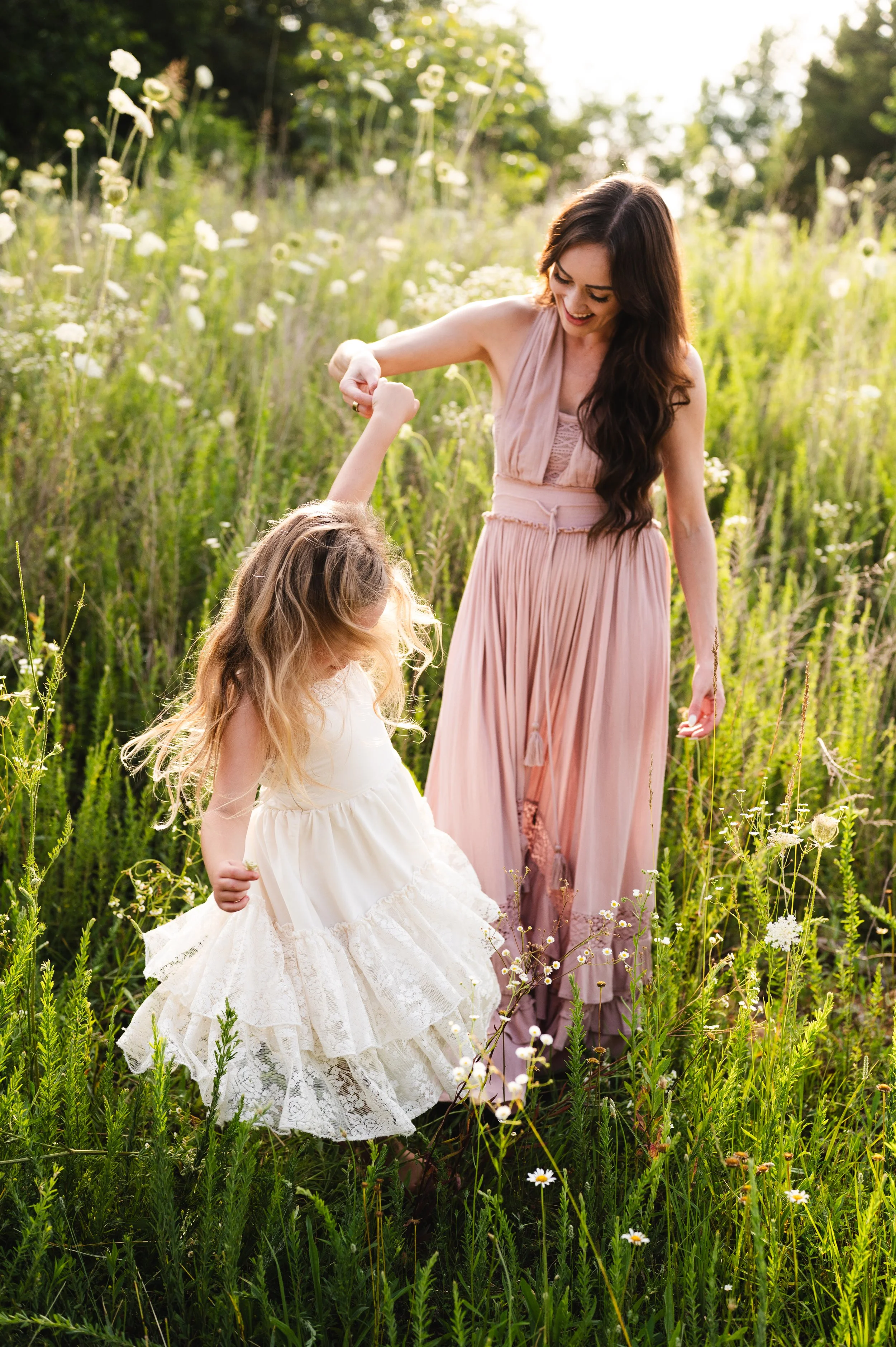 mother playing with daughter in flower field, motherhood, photographer, affordable, clarksville tennessee