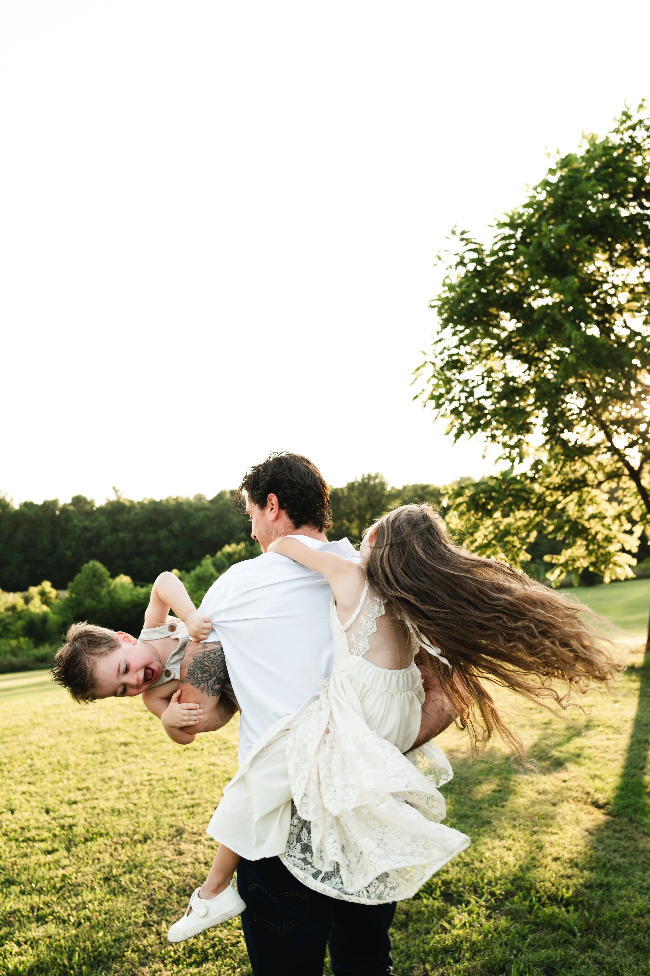 father playing with children outdoors, family photographer, affordable, clarksville tennessee, nashville