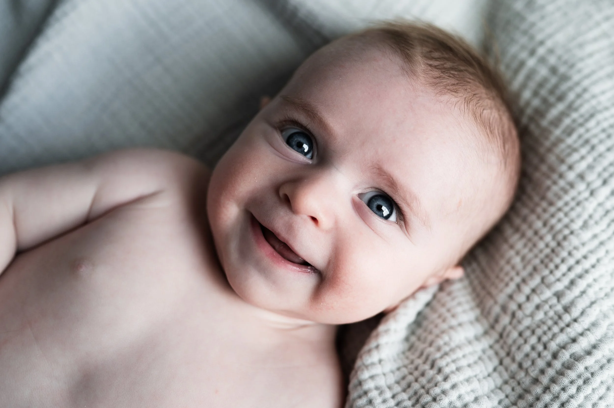 three month old baby boy with blue eyes lays on white muslin blanket, newborn photographer, family photographer, newborn and family, clarksville tn, nashville tn, affordable, milestone