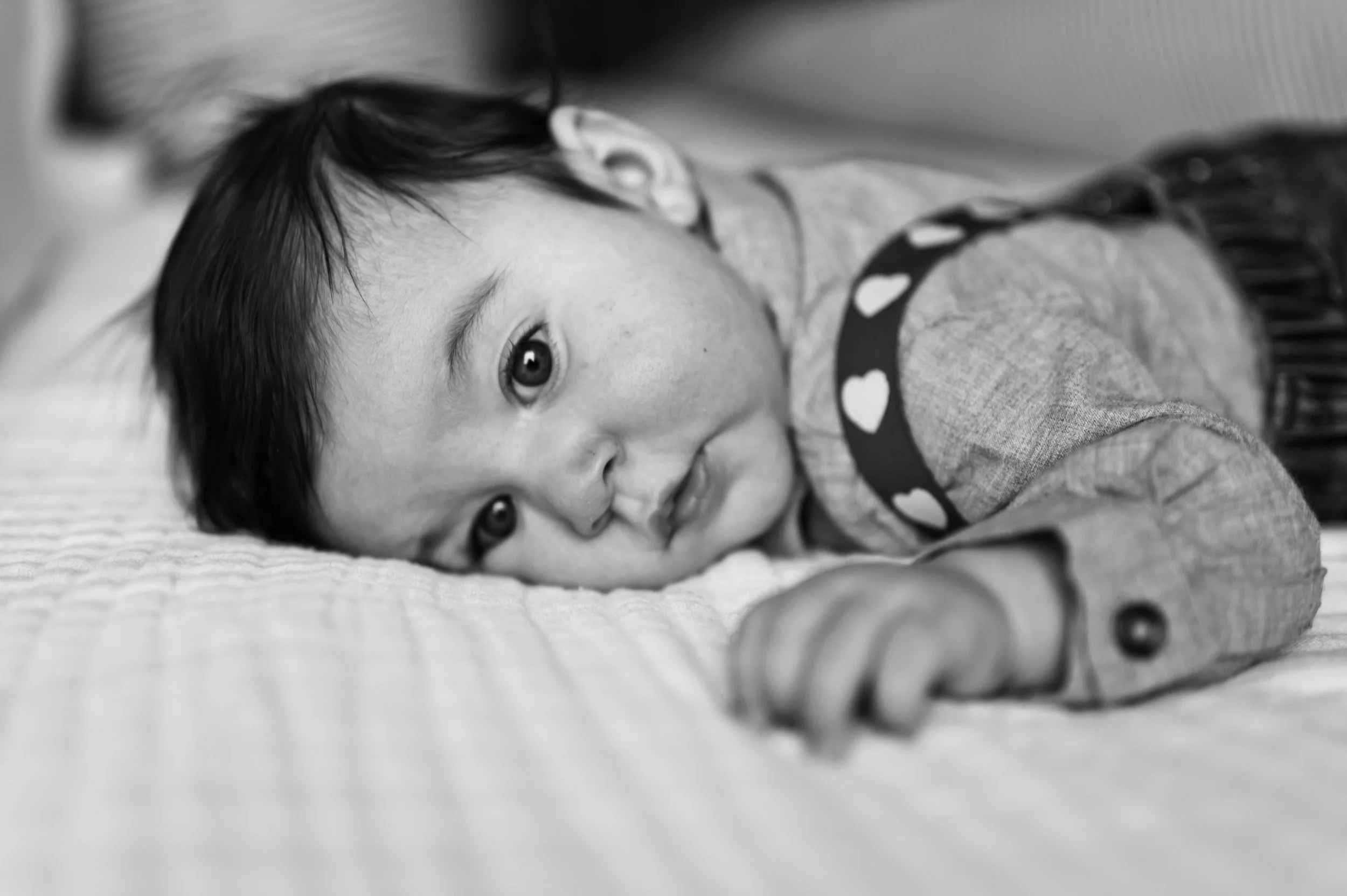 black and white photo of three month old boy laying on white blanket, clarksville tn photographer, nashville tn photographer, newborn photographer, milestone photographer, family photographer, affordable