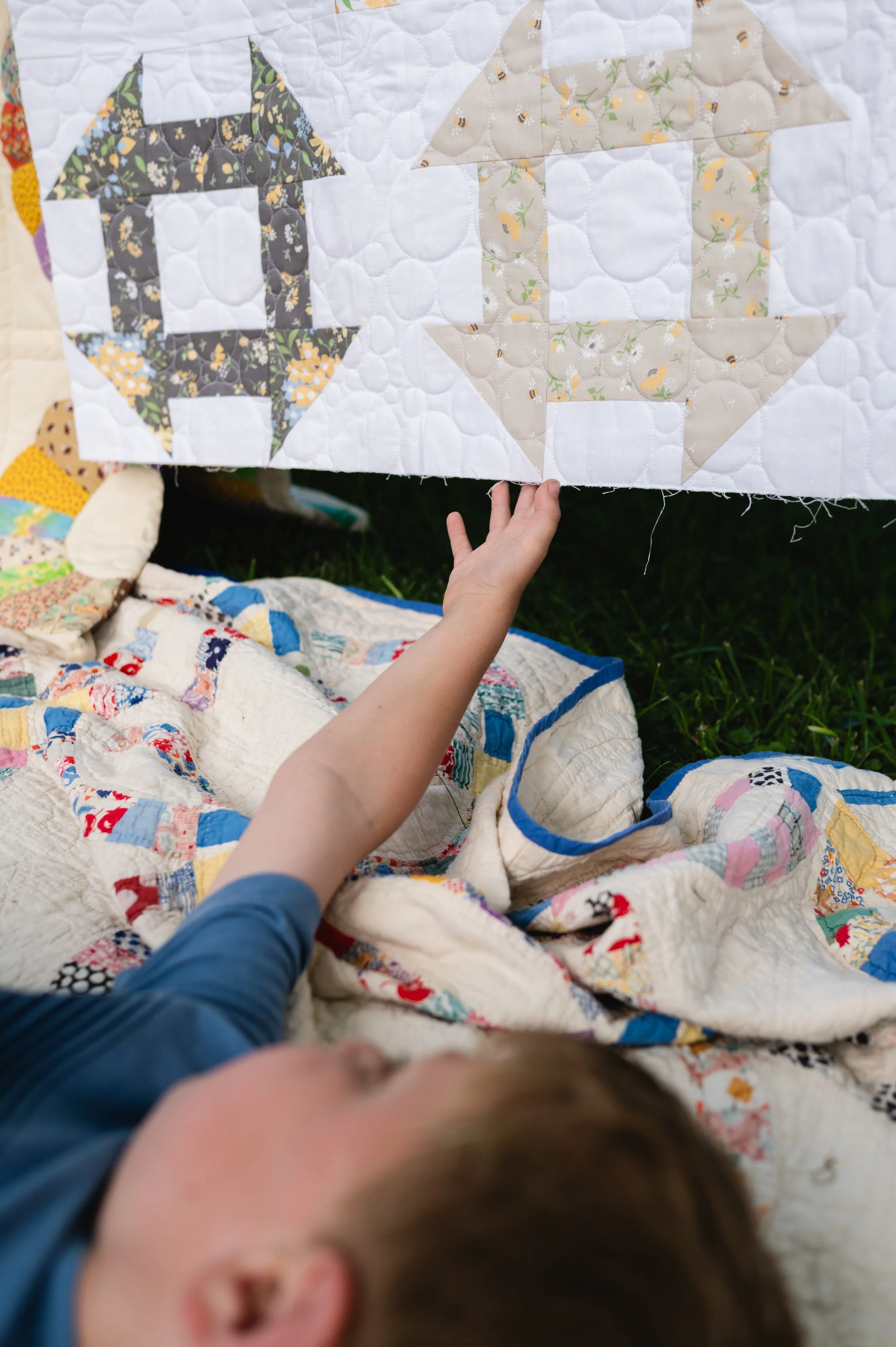 boy lays on quilts in grass, photographer clarksville tn, photographer nashville tn, family photographer