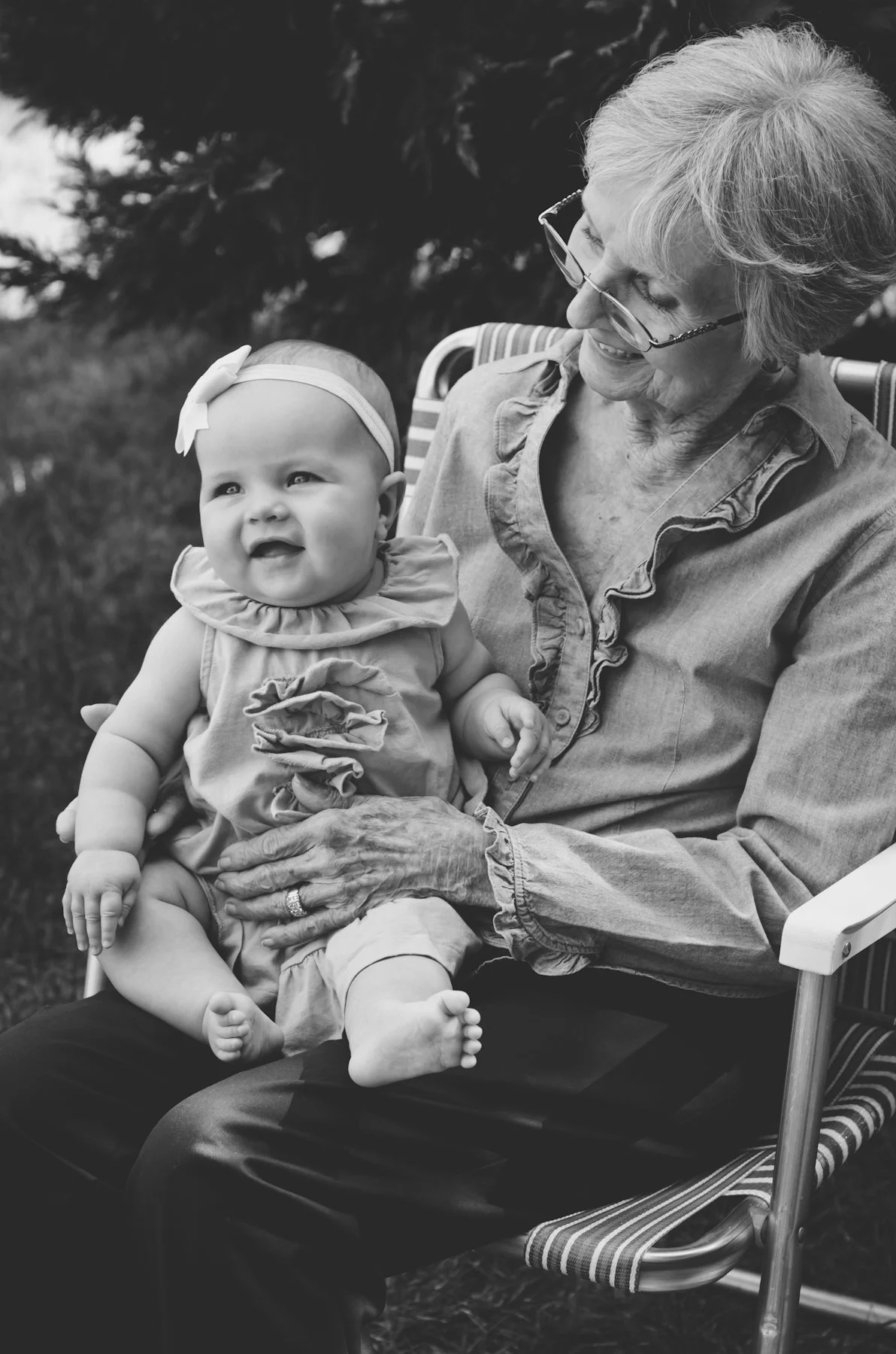 black and white portrait of grandmother holding granddaughter for outdoor extended family session, photographer, clarksville tn, nashville tn, affordable, family photographer, generational, legacy, lifestyle, film