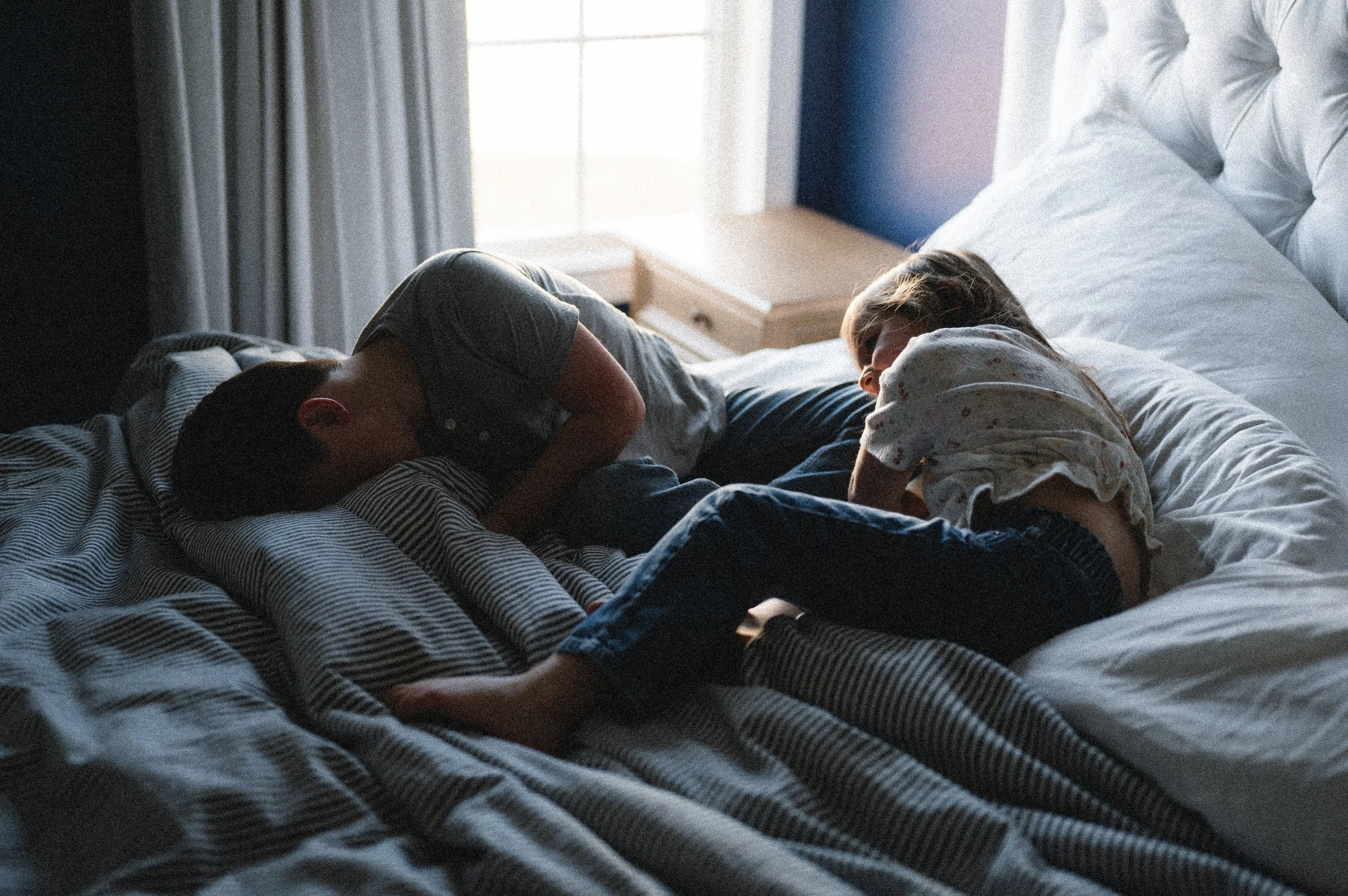 silhouette portrait of young boy and girl laying in bed laughing, clarksville tennessee, nashville tennessee, photographer, affordable, documentary, lifestyle, family photographer