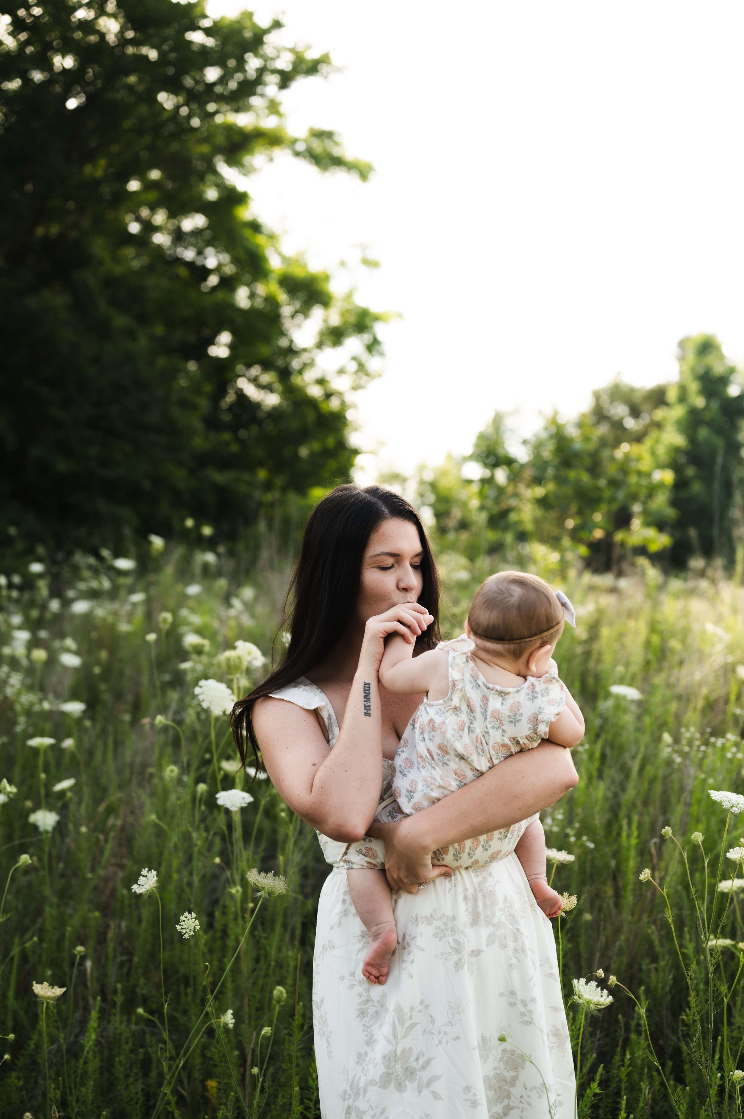 mother and baby in white flower field, nashville, motherhood, photographer, clarksville tennessee