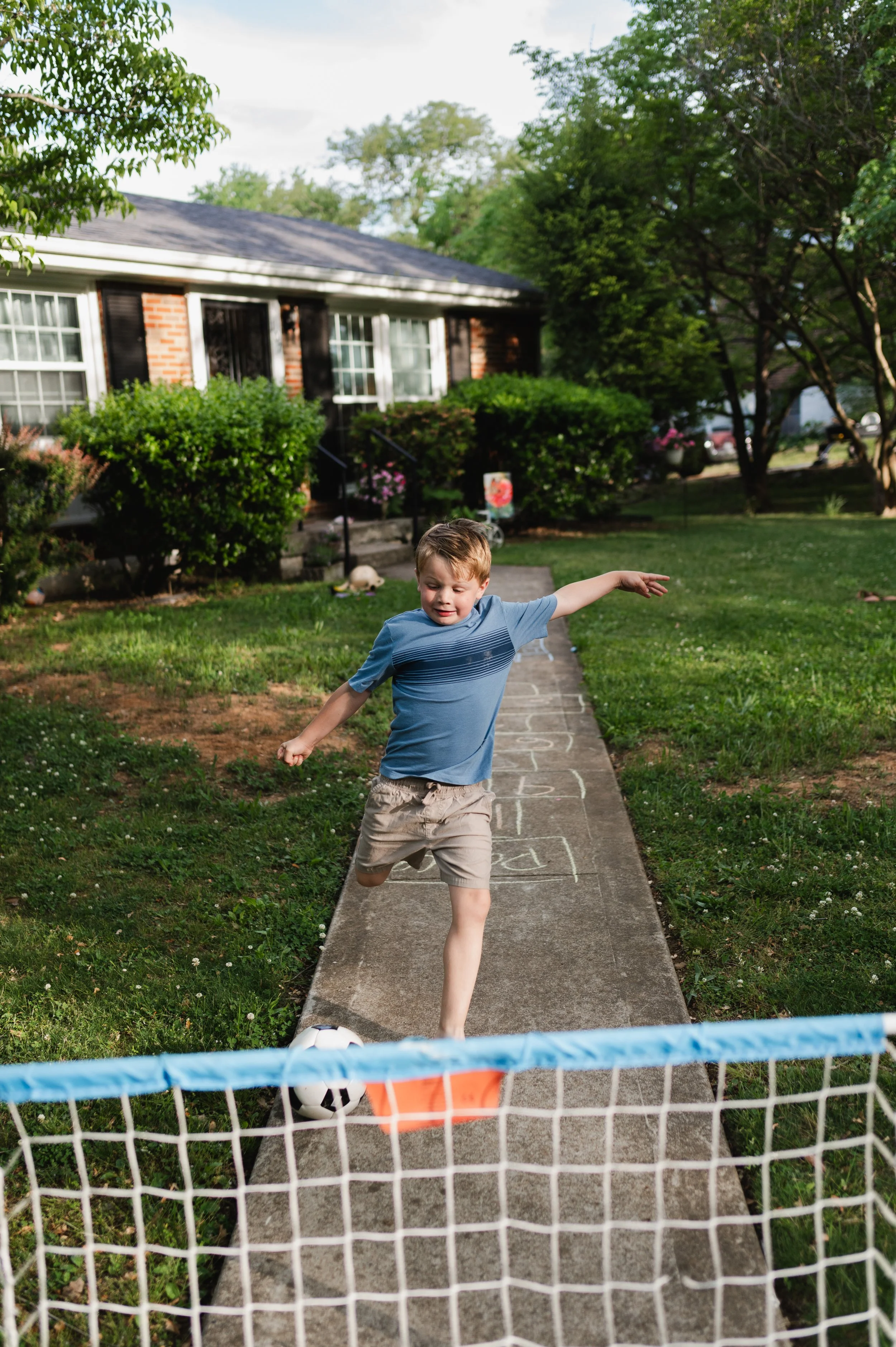 boy kicks soccer ball, clarksville tn, affordable, nashville tn, family photographer, family photos, storytelling family photography