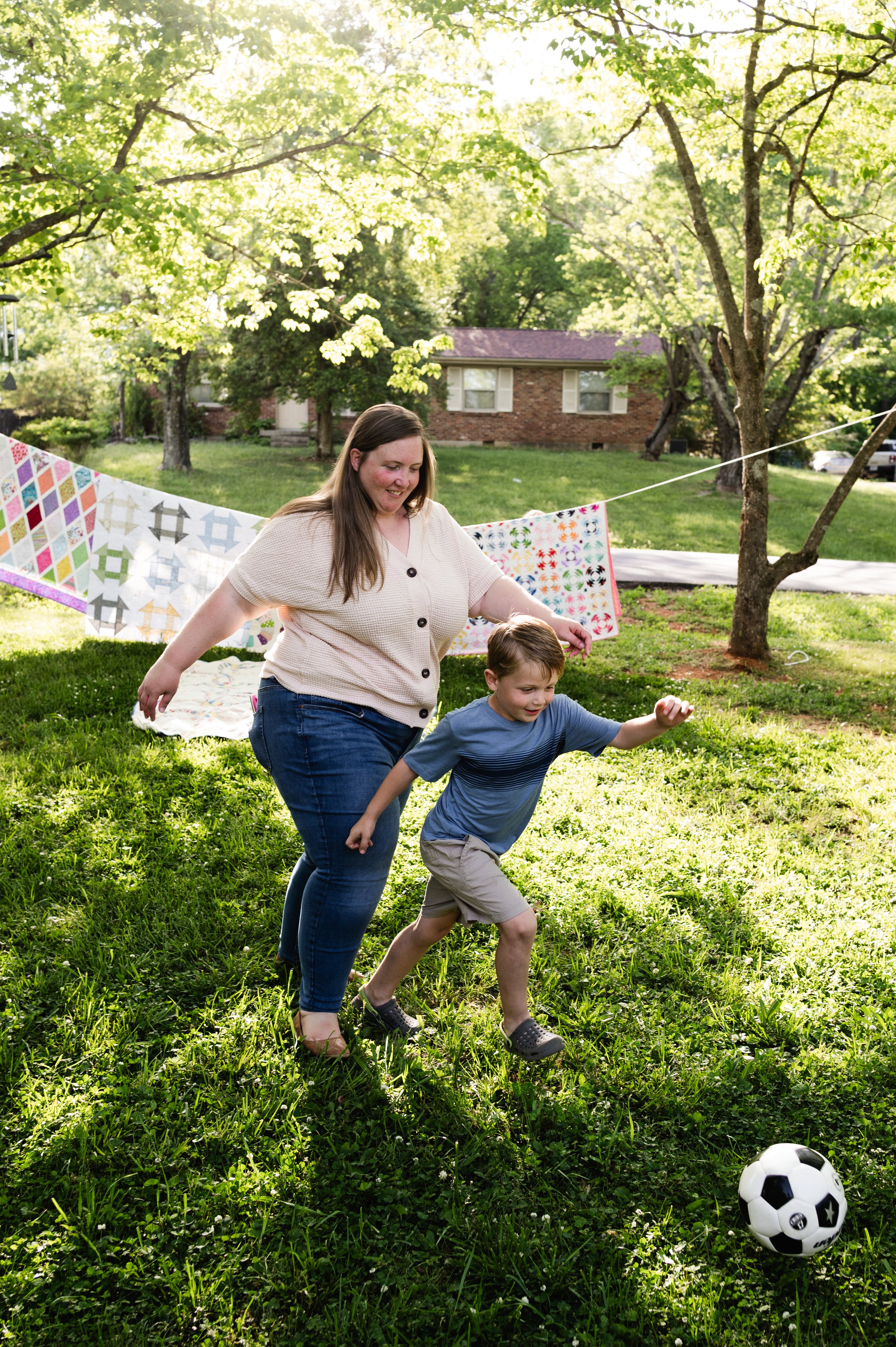 mother and son play soccer in yard, motherhood photographer, clarksville tennessee, nashville tennessee, affordable
