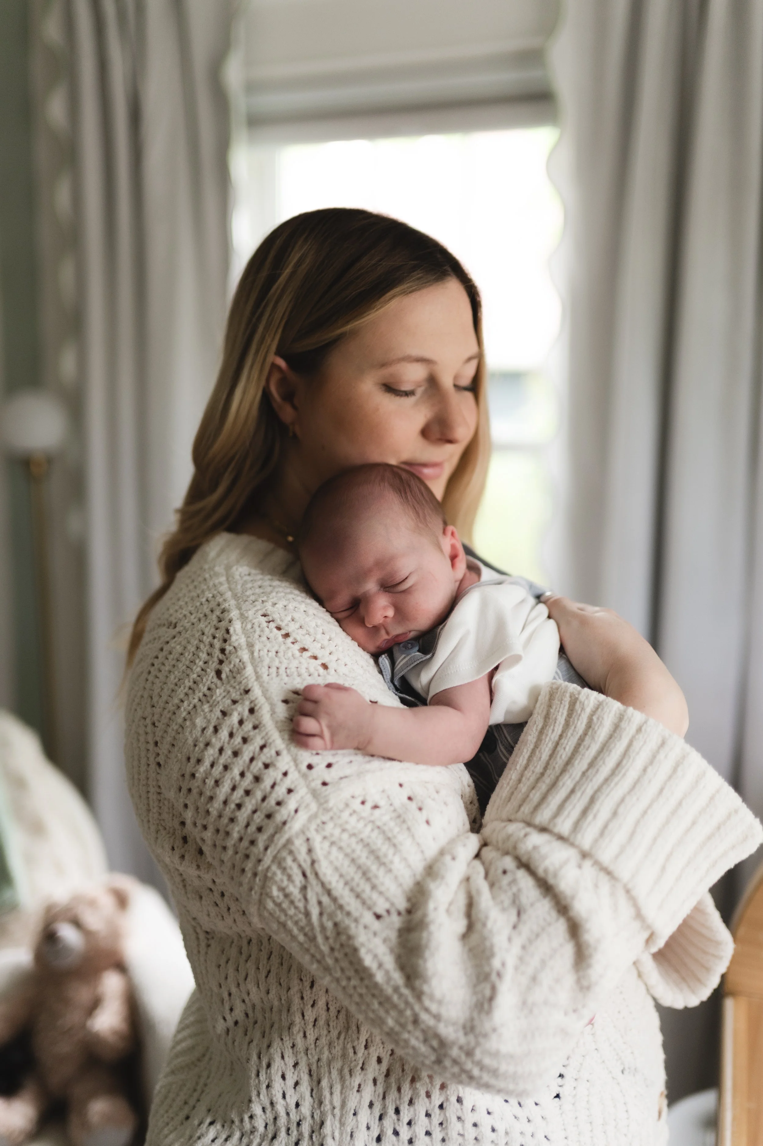 woman with baby in nursery, clarksville tn newborn photographer, nashville tn newborn photographer, photographer, affordable