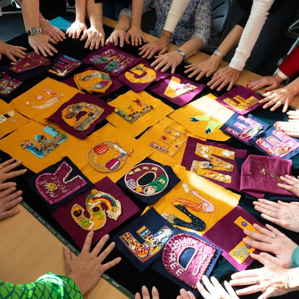 Over the past few weeks, women connected to and supported by four local charities, have sewn their personal stories of what it means to be a woman into every letter of the Madge Turner Flag - one side reading DARE TO BE FREE, the other WOMEN&rsquo;S 