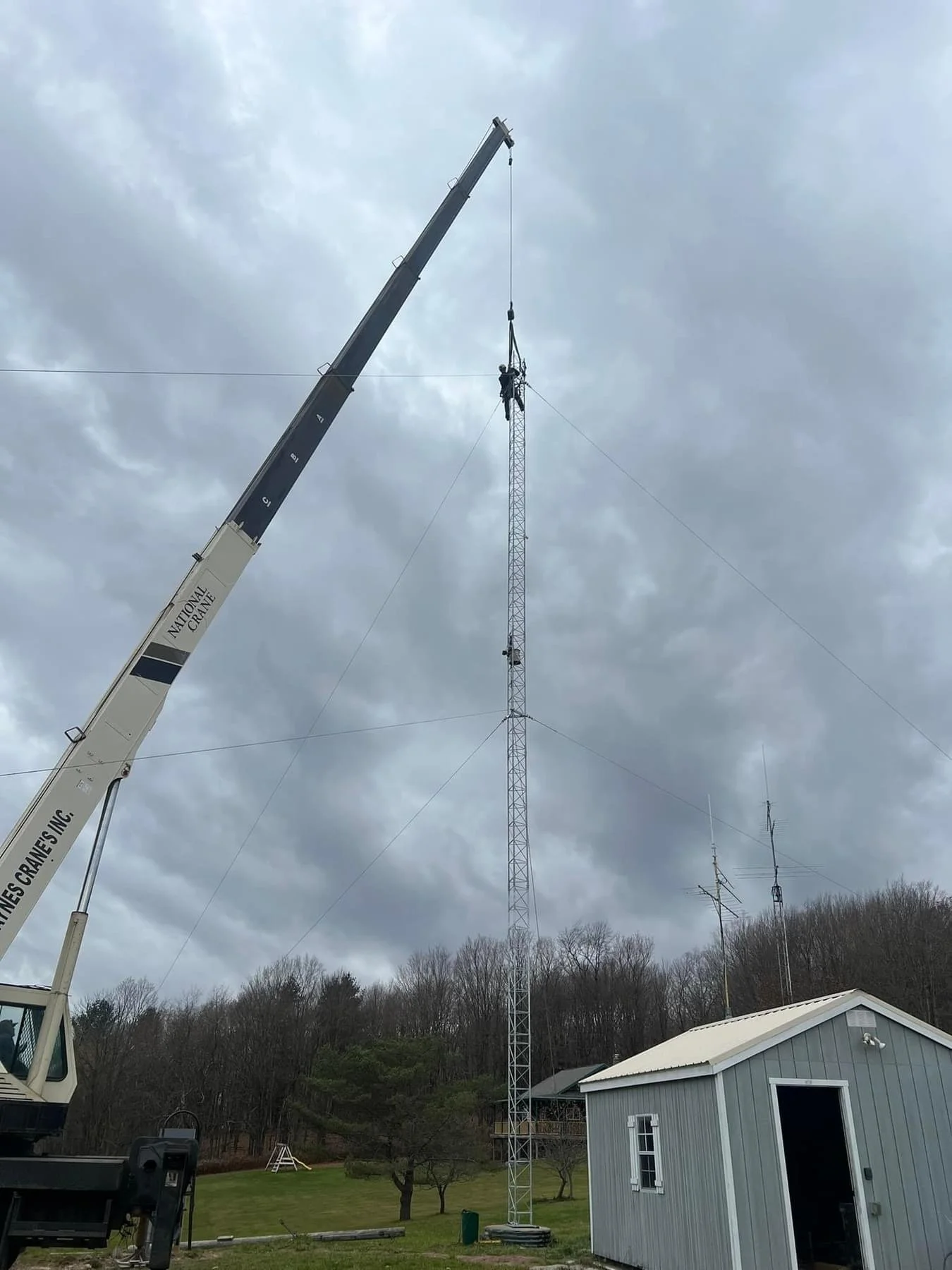 Crane-assisted tower access for antenna installation — man basket and rigging contractor serving New England and nationwide