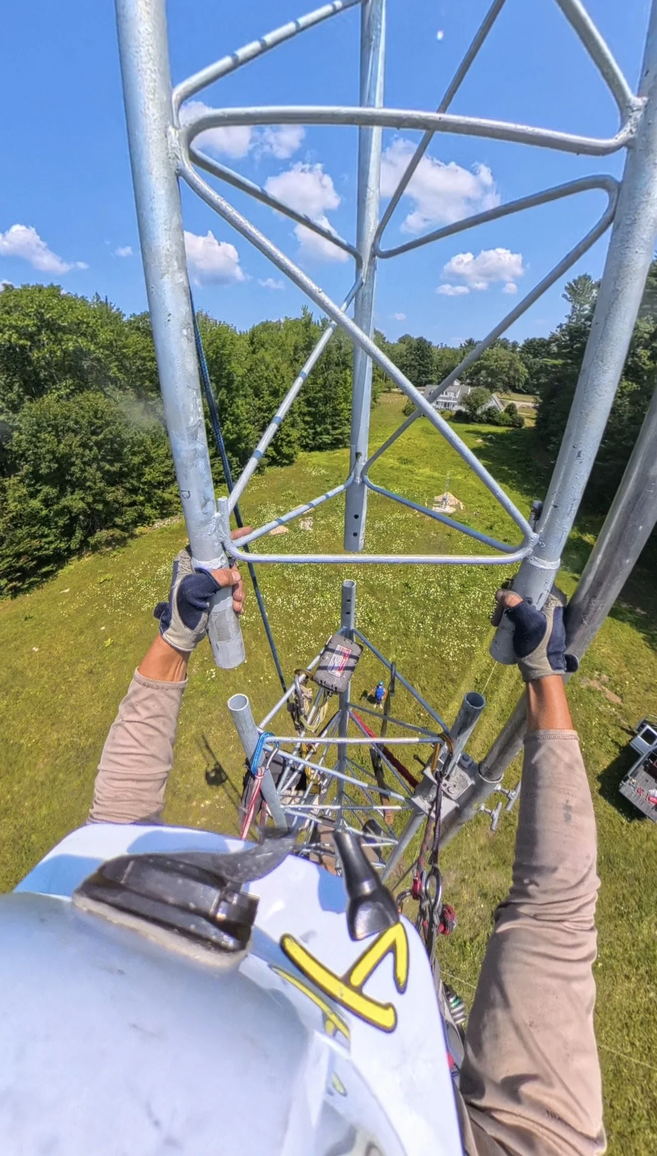 Tower climber working at height on communications tower — certified tower climbing and antenna installation contractor, New England and nationwide