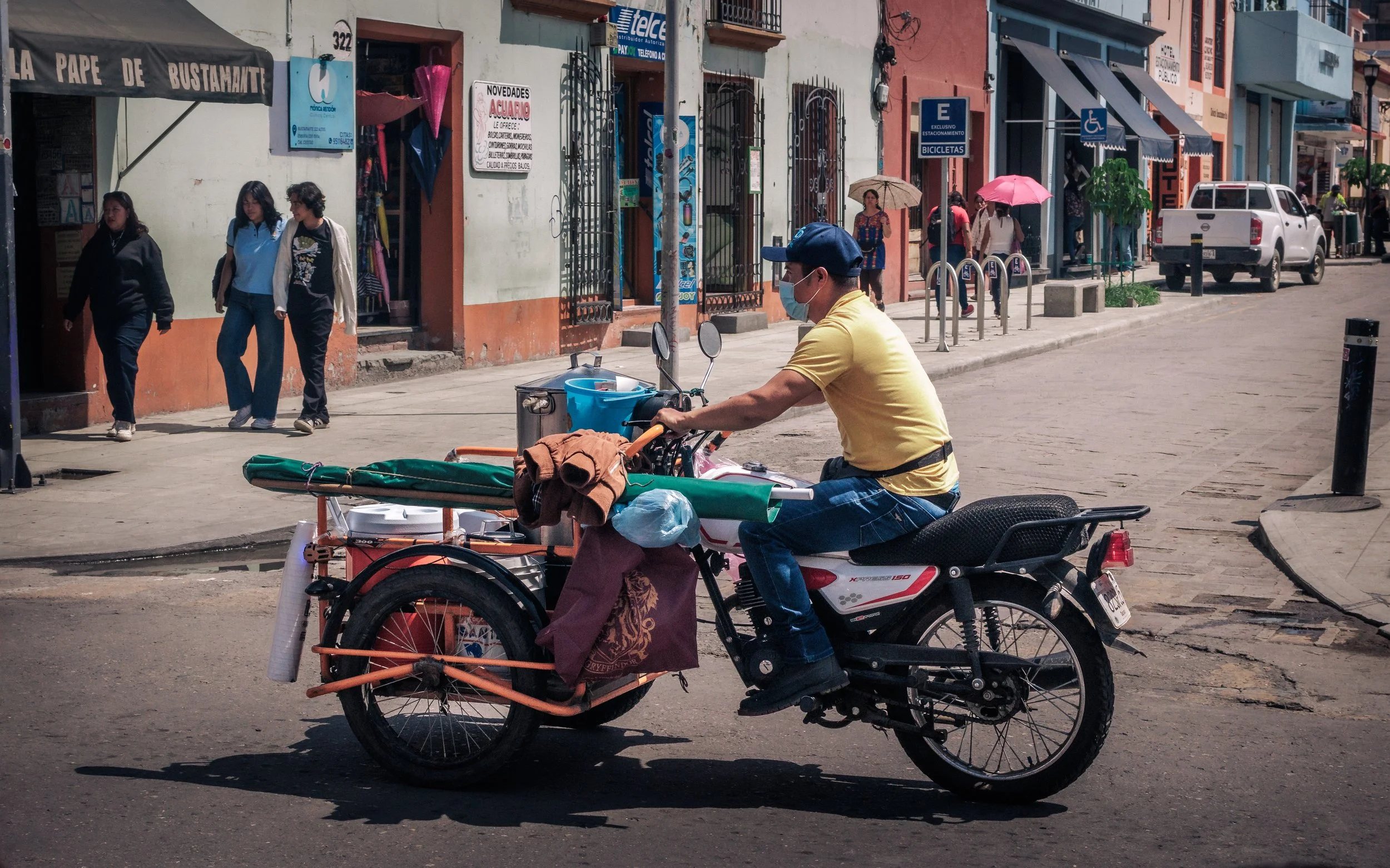 A candid street photograph of a local on his motorbike, captured on the vibrant streets of Mexico.