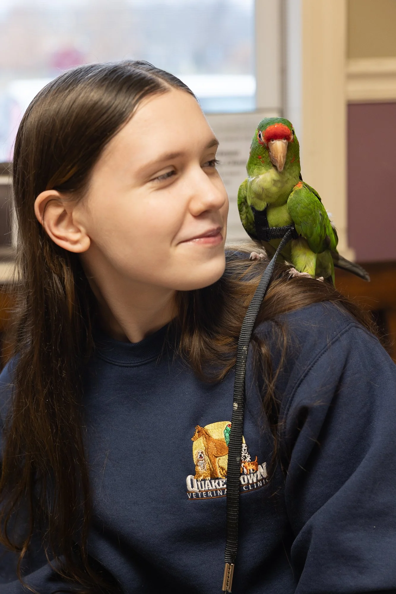 People having a discussion at a conference table with notebooks, coffee, and water bottle in a professional setting.