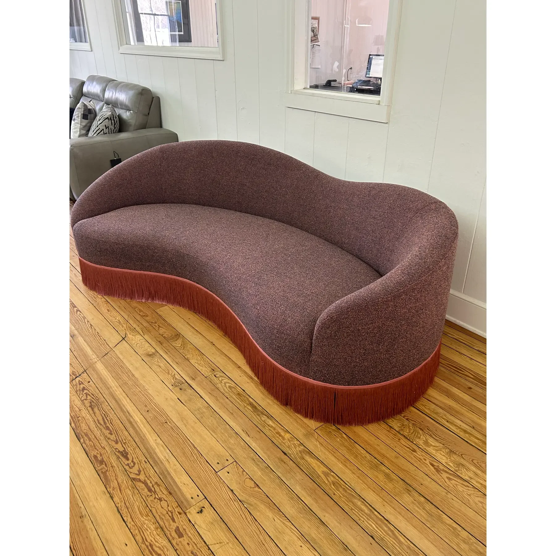 curved-sofa-custom-upholstered-in-maharam-gale-fabric-color-diorite-see-photos-and-trimmed-in-pink-fringe-8831.webp