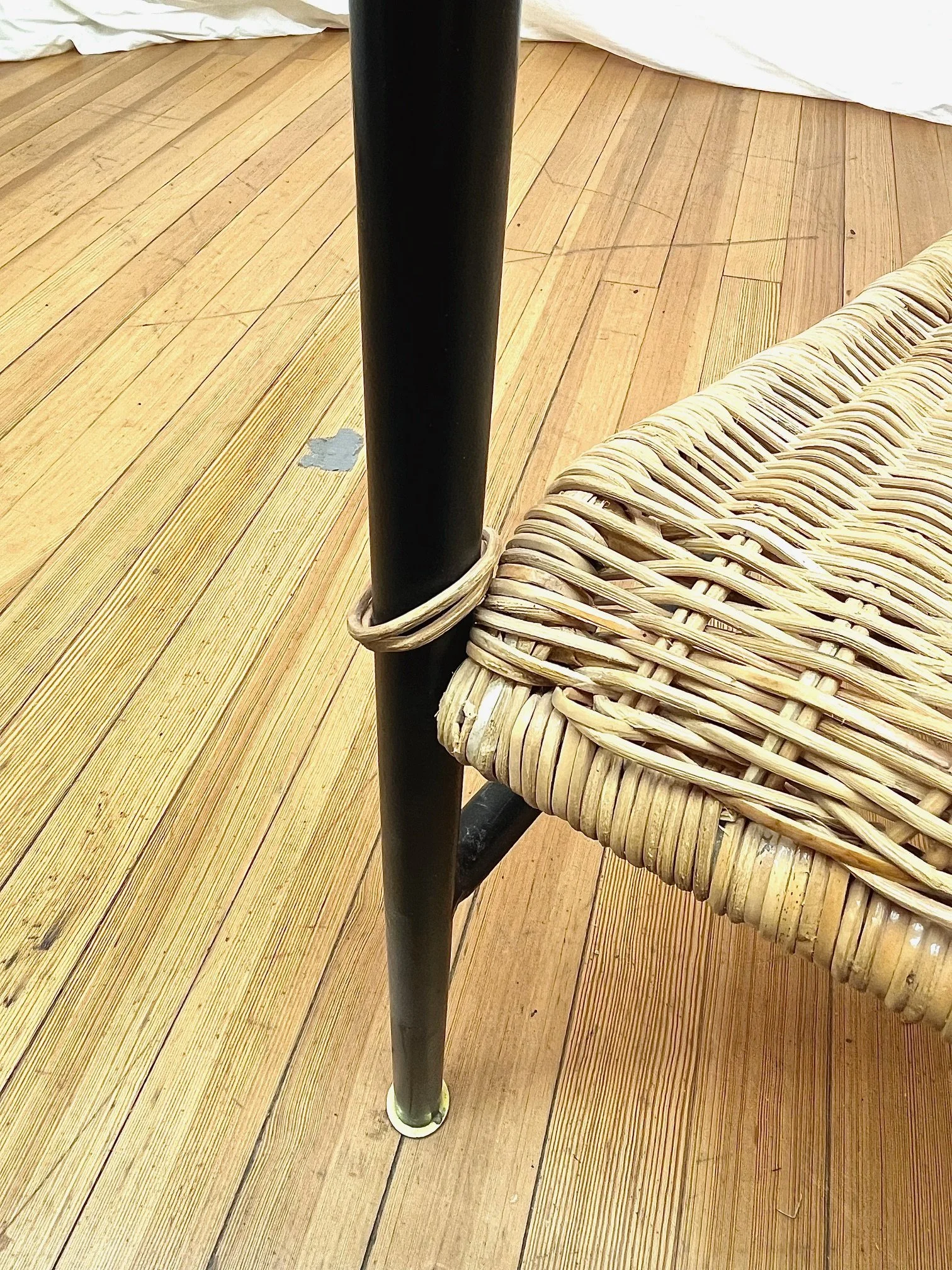 woven-rattan-armchairs-black-metal-frame-metal-detail.jpg