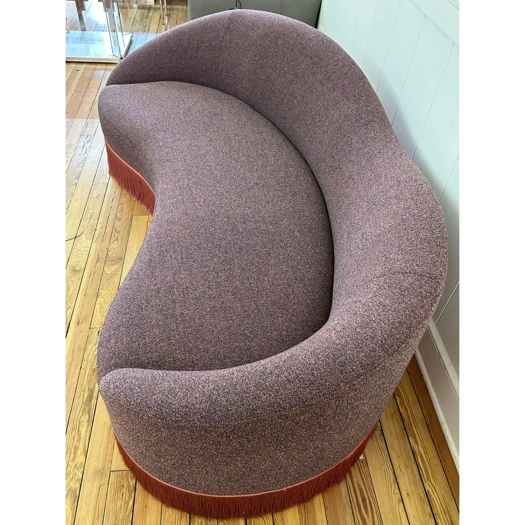 curved-sofa-custom-upholstered-in-maharam-gale-fabric-color-diorite-see-photos-and-trimmed-in-pink-fringe-0645.webp
