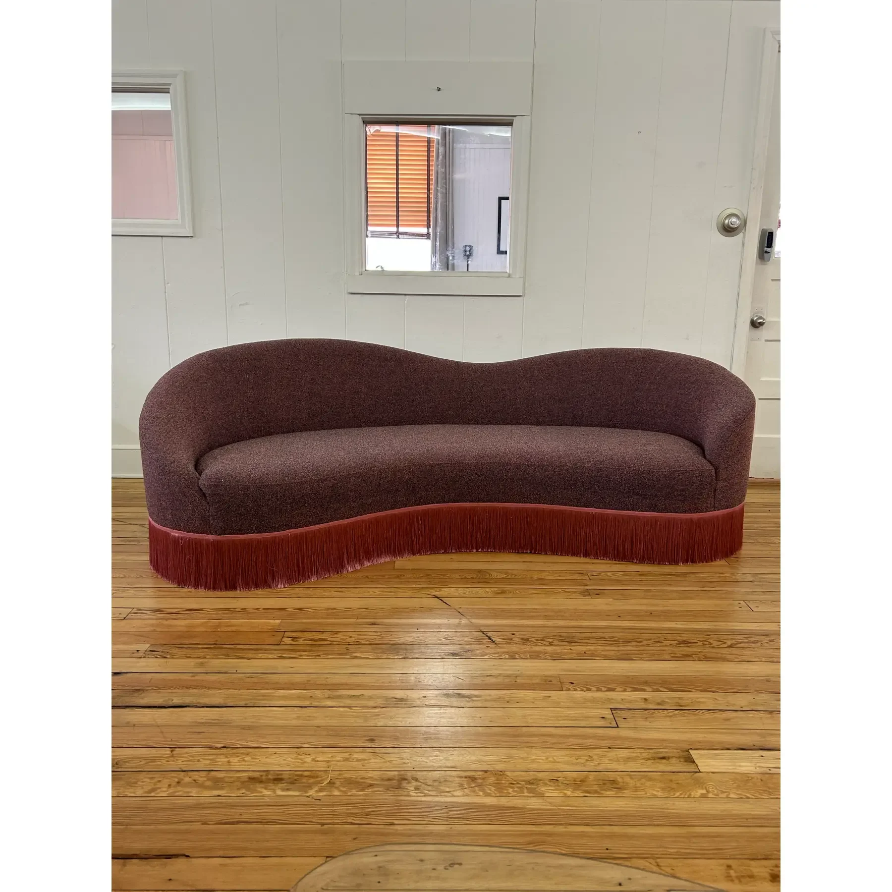 curved-sofa-custom-upholstered-in-maharam-gale-fabric-color-diorite-see-photos-and-trimmed-in-pink-fringe-5380.webp