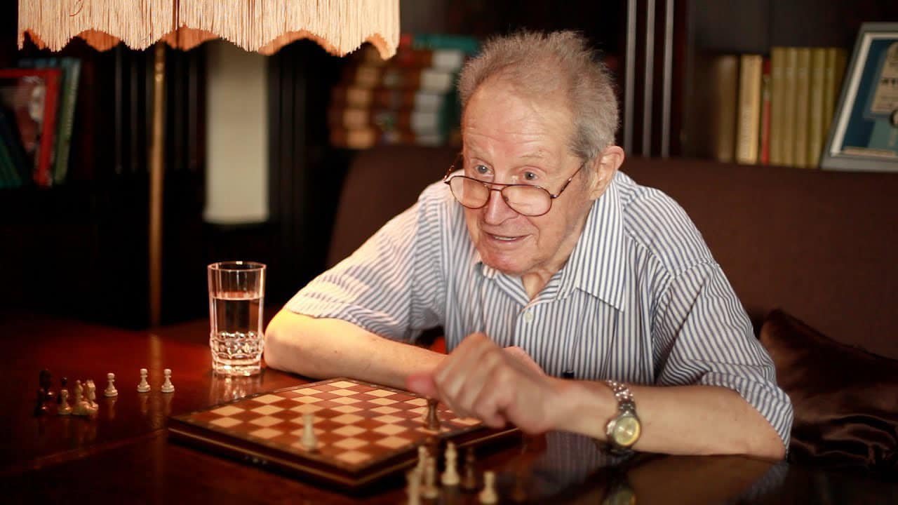 Yuri Averbakh sitting at a chess board