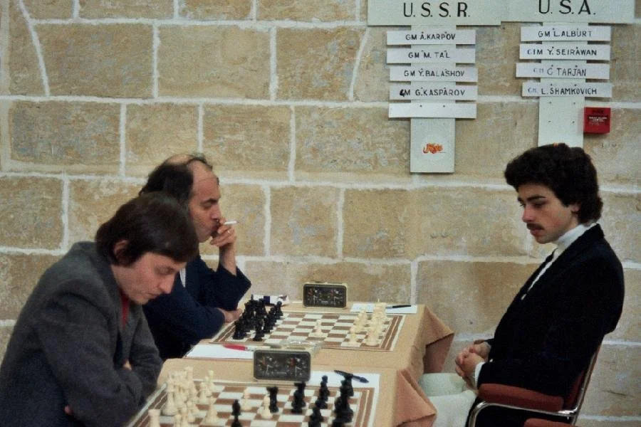 Karpov, Tal, and Seirawan seated at a table.