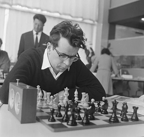 Pal Benko thinking about his move in front of a chessboard