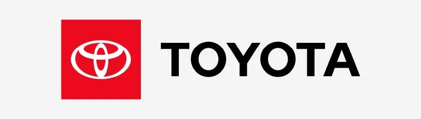 Toyota logo with red emblem and black text on a white background.