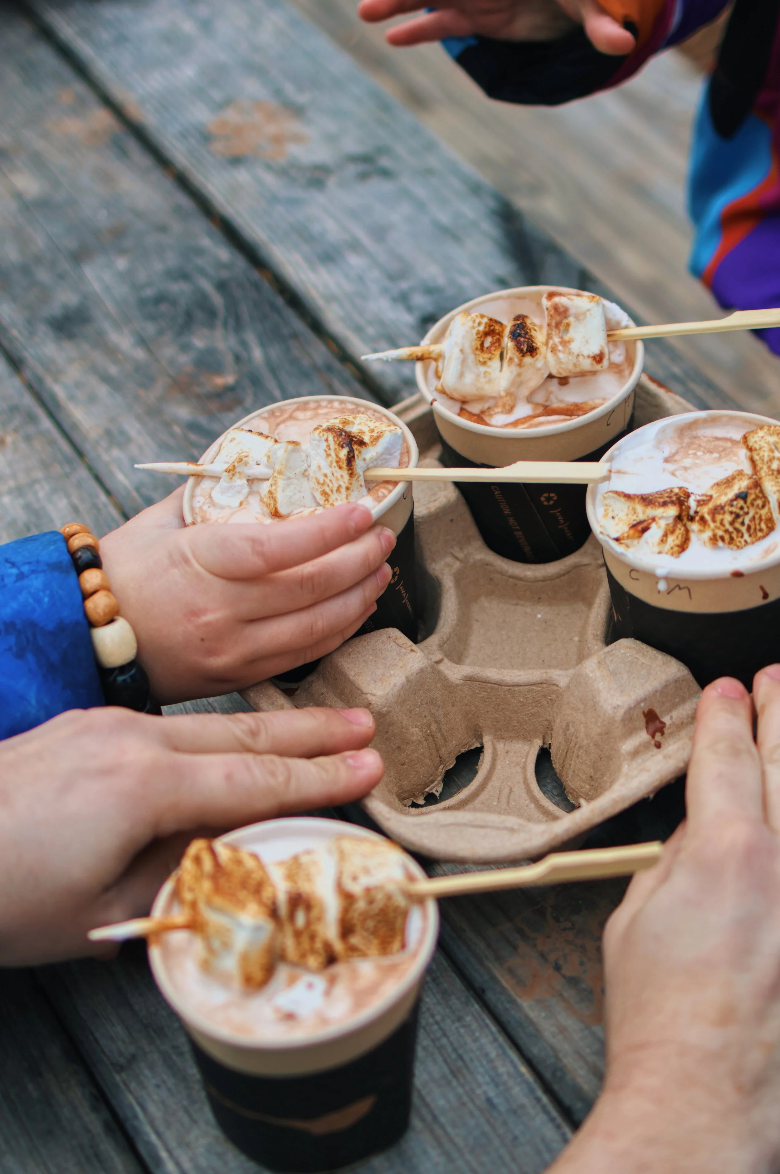 kids reaching for hot cocoa