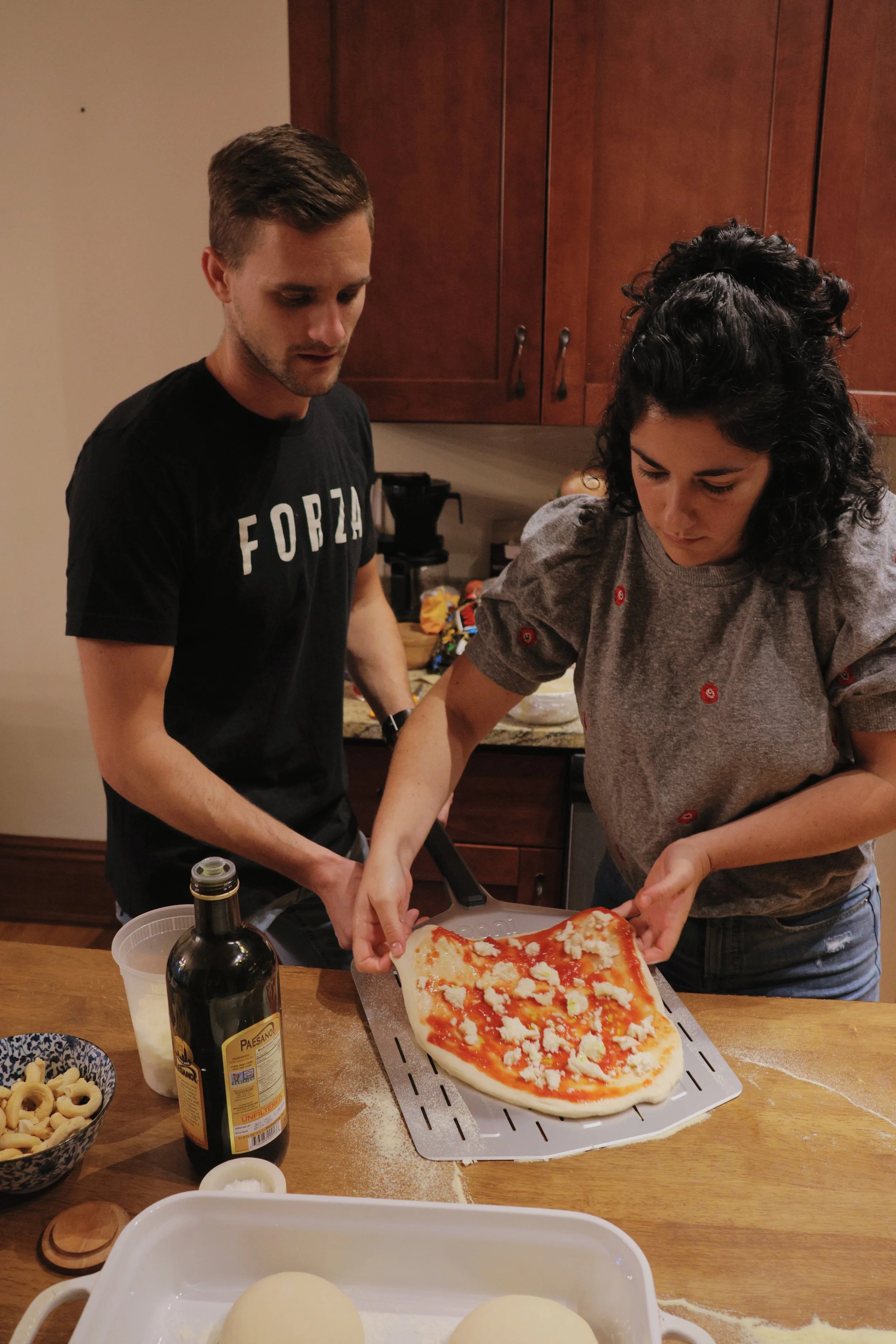 couple making pizza at home