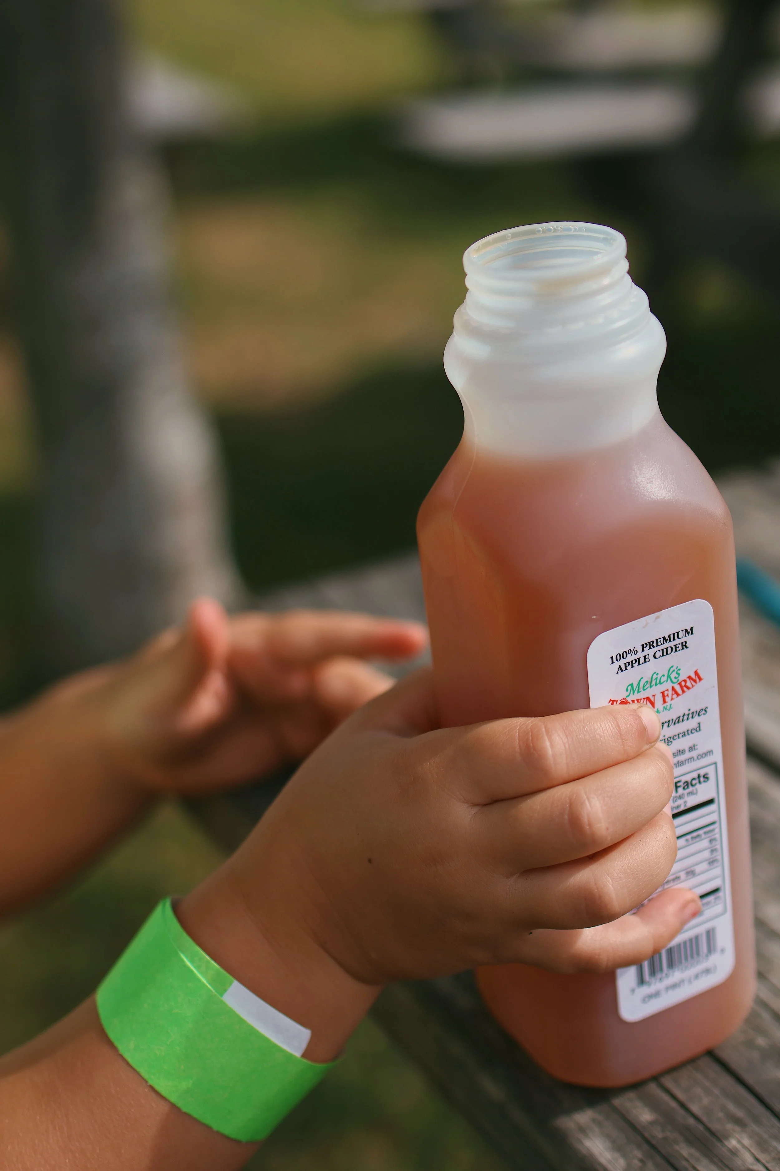 child holding apple cider 