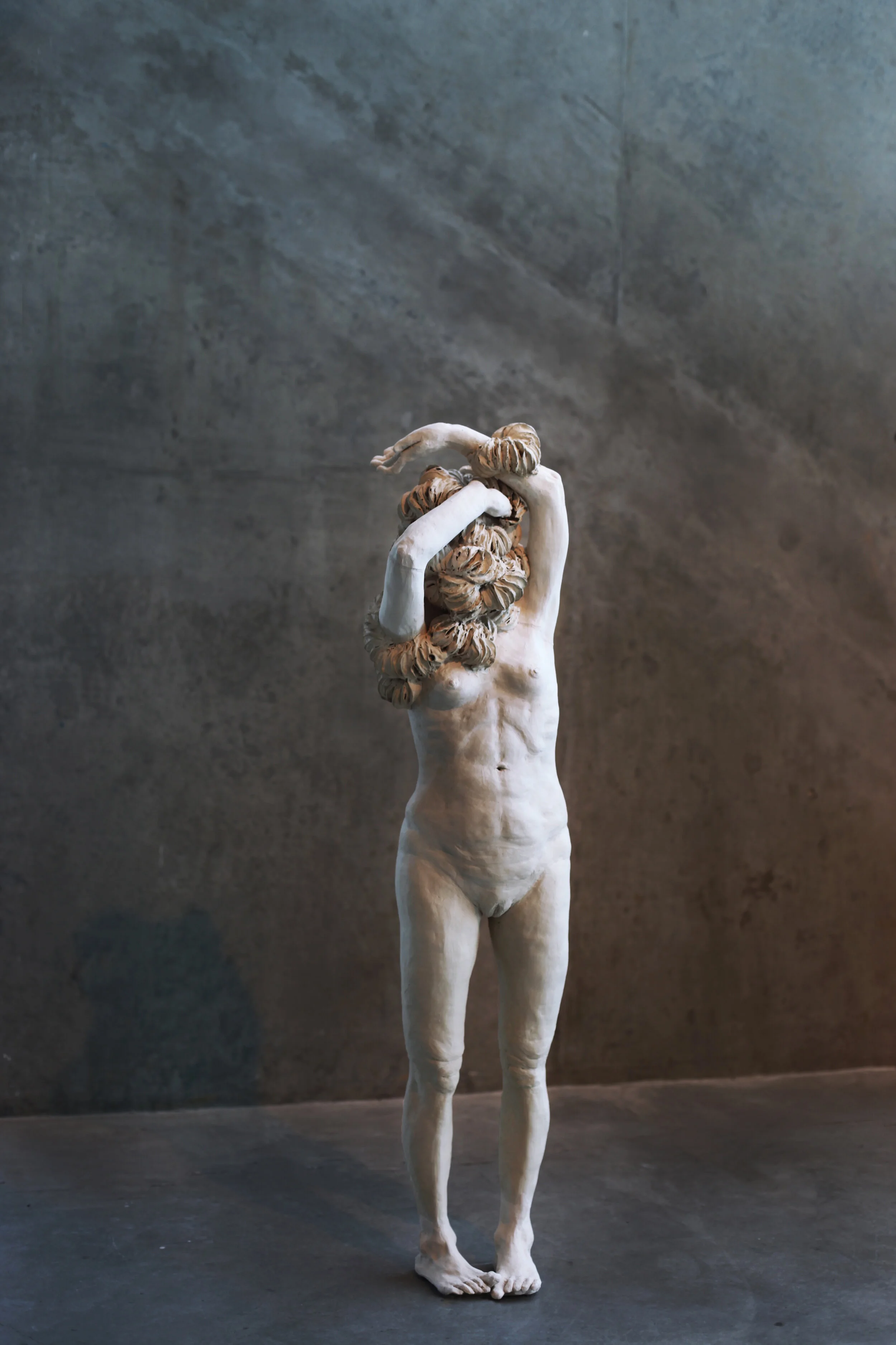 Changing Skin , 48x20x14, stoneware clay, burnt out cosmetic pads