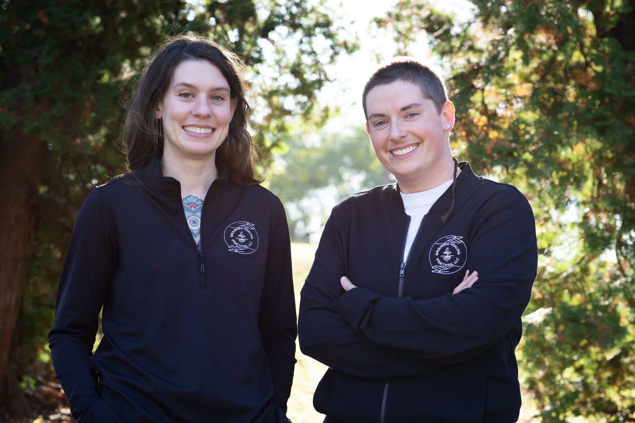 Picture of Molly (left) & Morgan (right) in front of pine trees at Glen Park in River Falls, WI
