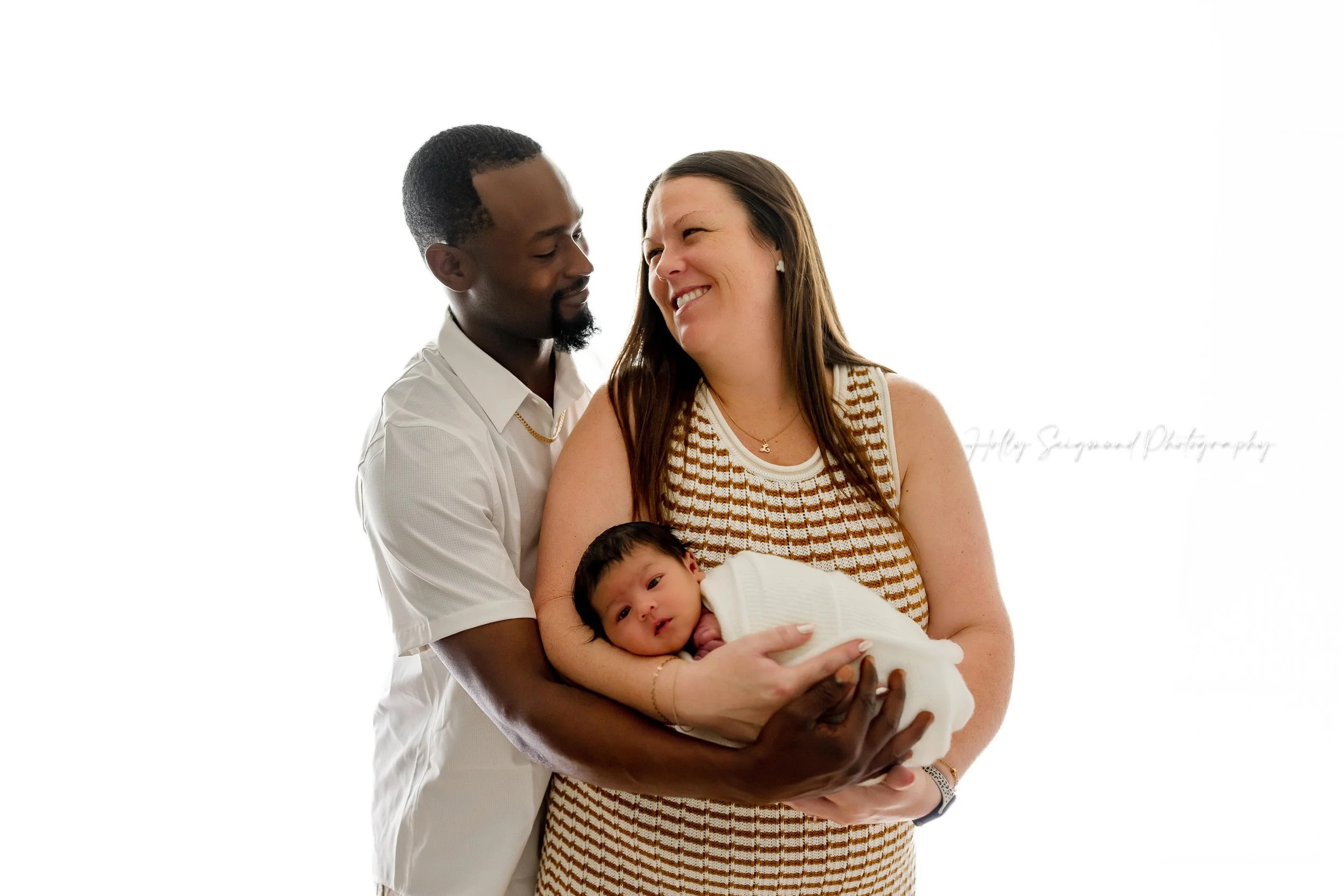 Mom, dad and baby during a family newborn session in Lexington, Texas