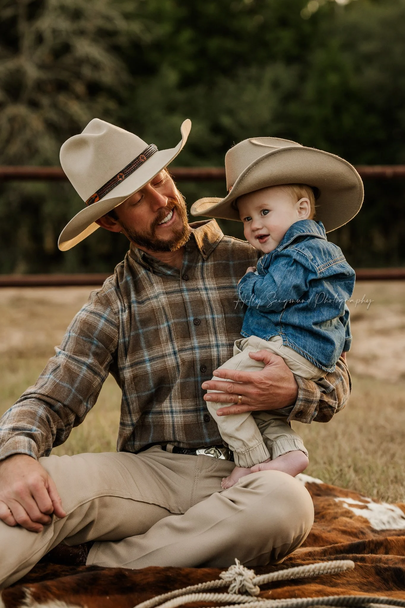 Cowboy and dad during a outdoor natural light first birthday session in Central Texas
