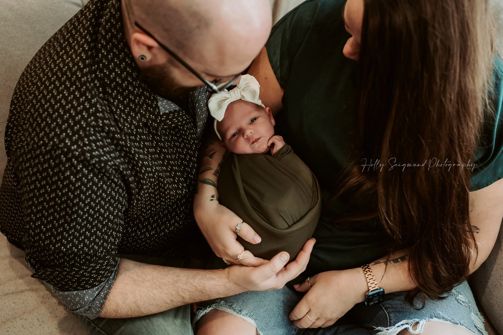 Mom and dad holding baby during an in-home newborn session in Central Texas
