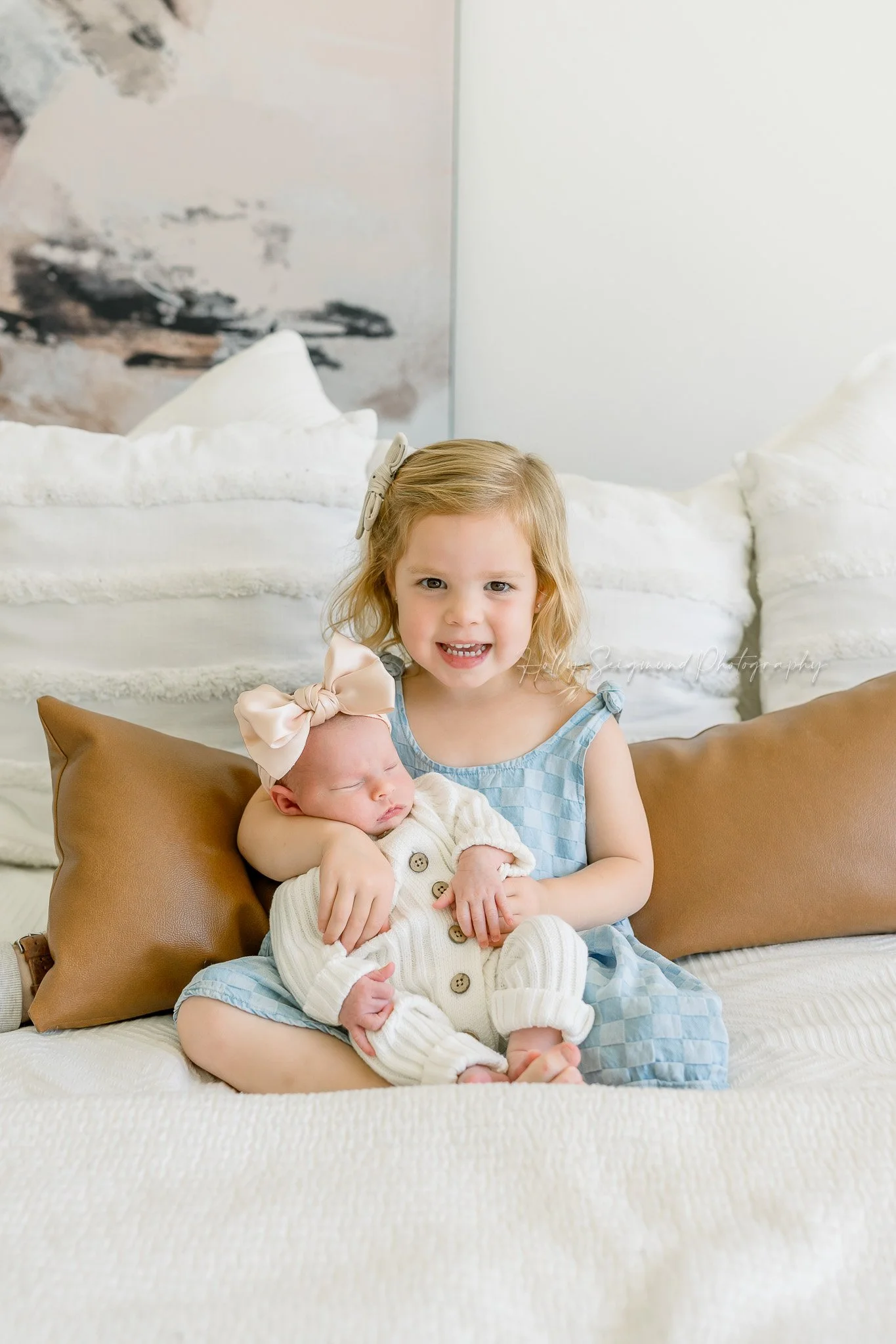 Sister and new baby sister during a lifestyle newborn session in Central Texas