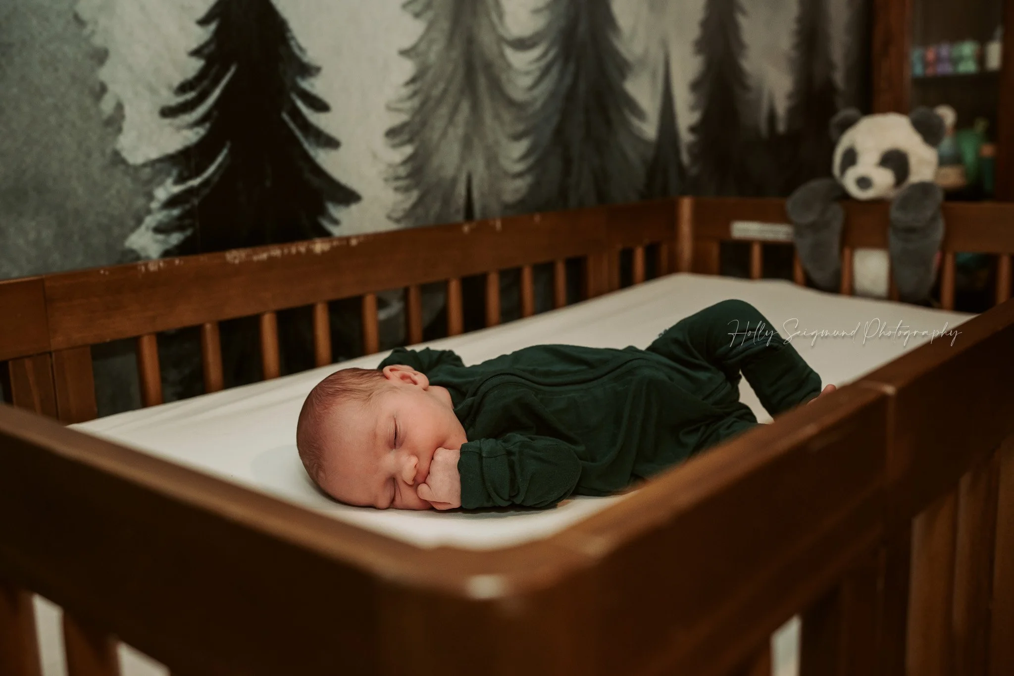 Baby in crib in nursery during a lifestyle newborn session in Central Texas