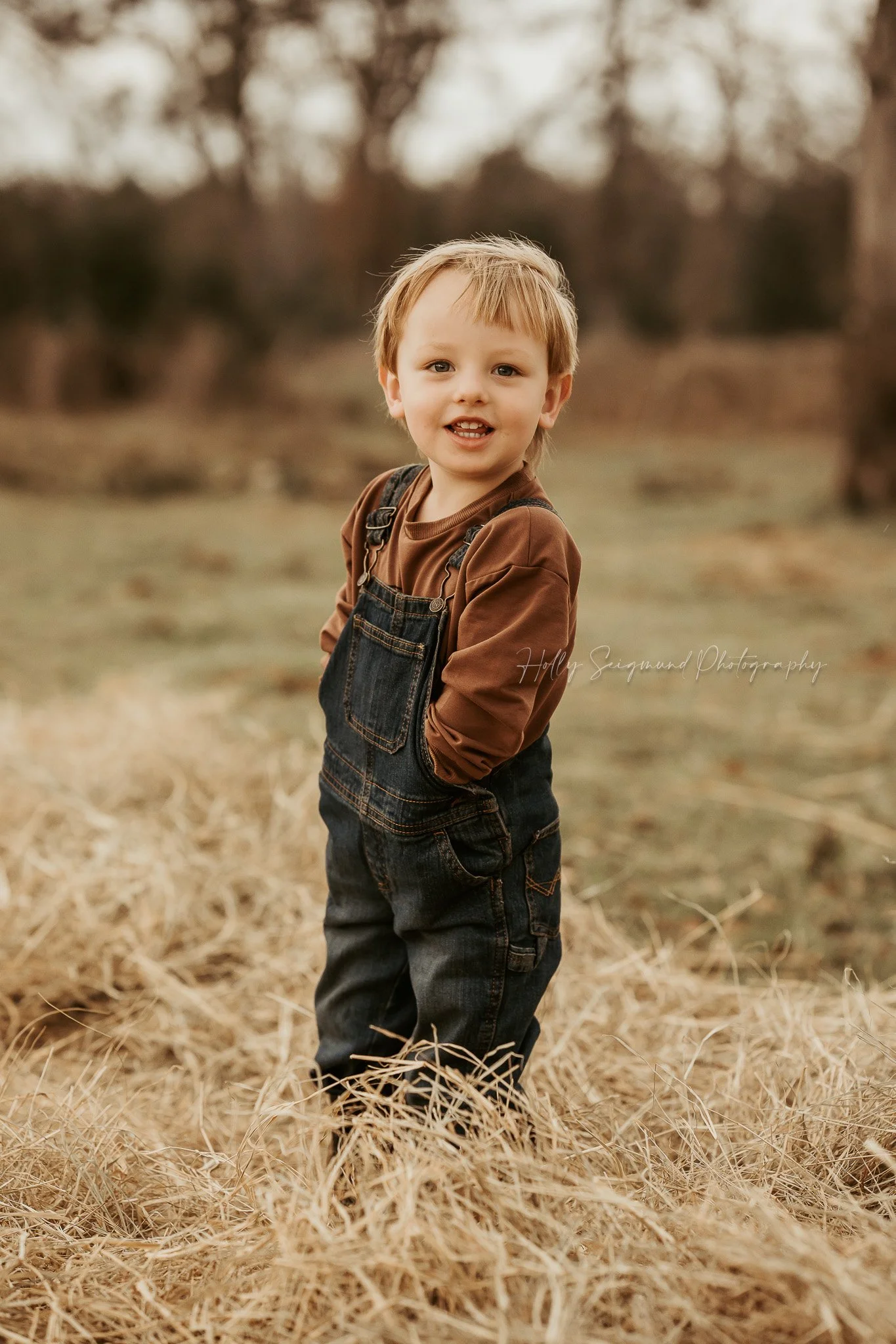 child posing in a rustic field during a birthday photoshoot in the Texas countryside