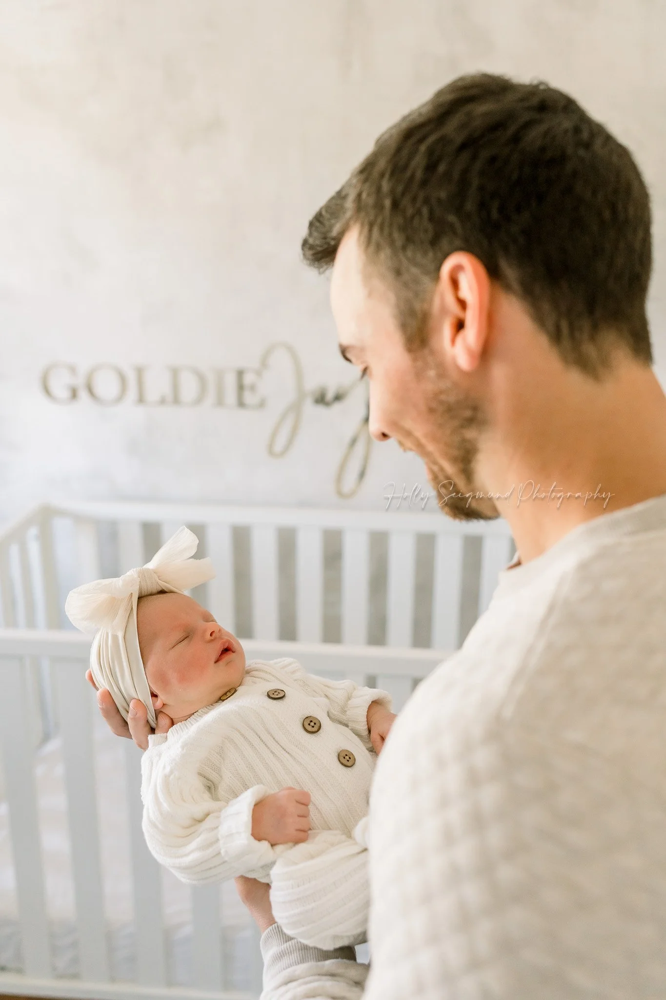Dad and newborn daughter during a lifestyle newborn session in Central Texas