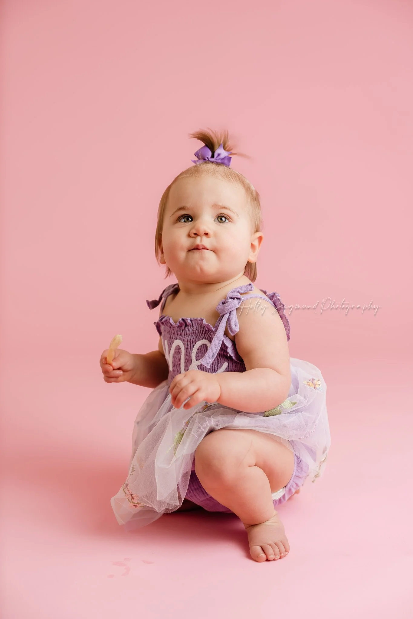 Simple pink backdrop girls first birthday photos with flash photography in a studio near Elgin, Texas