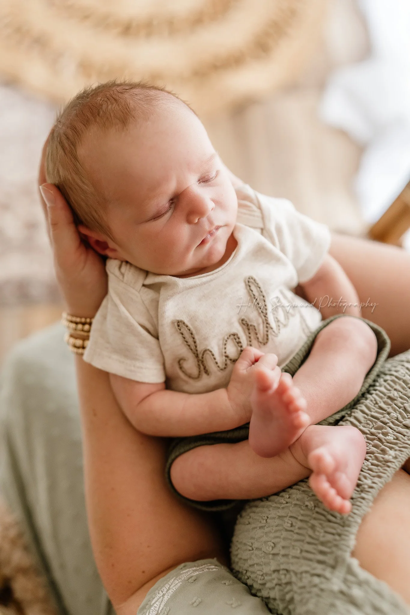 Newborn baby boy in personalized outfit in a newborn studio in Central Texas