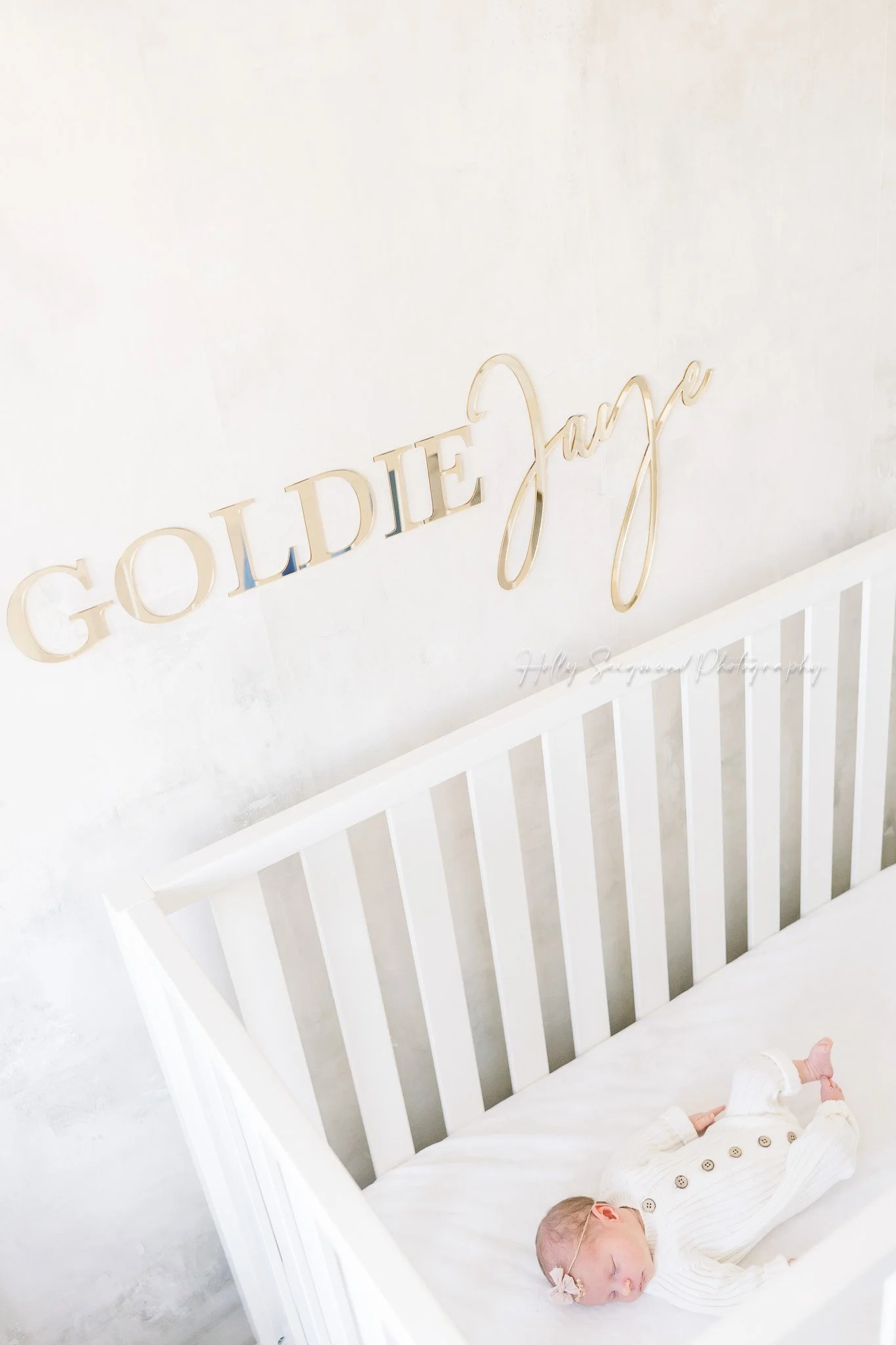 Newborn in a crib during an in-home newborn session in Central Texas