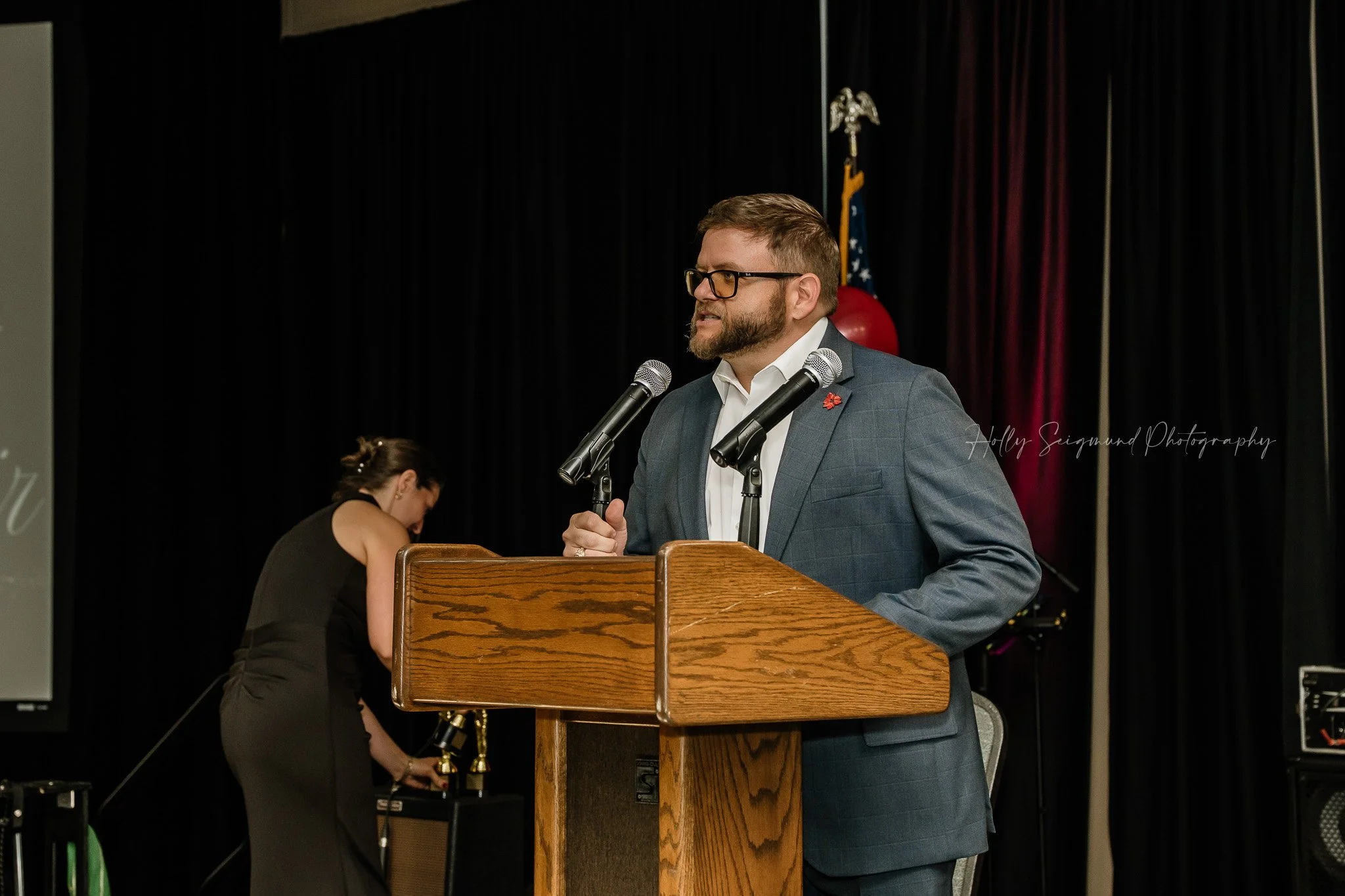 Speaker on stage at Down Home Ranch gala event in Bastrop Convention Center