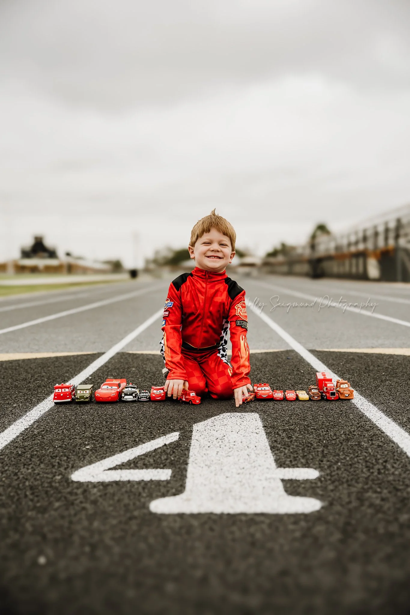 4th birthday photos of a boy with a race track themed setup in Giddings Texas