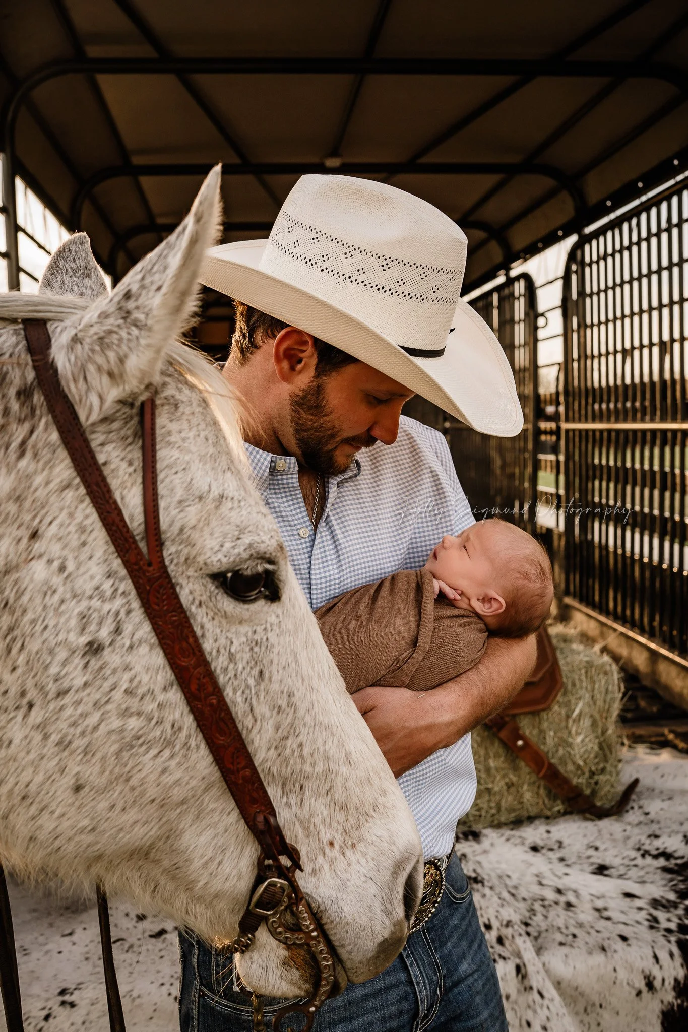 Newborn, dad and horse in a cattle trailer in Lee County Texas