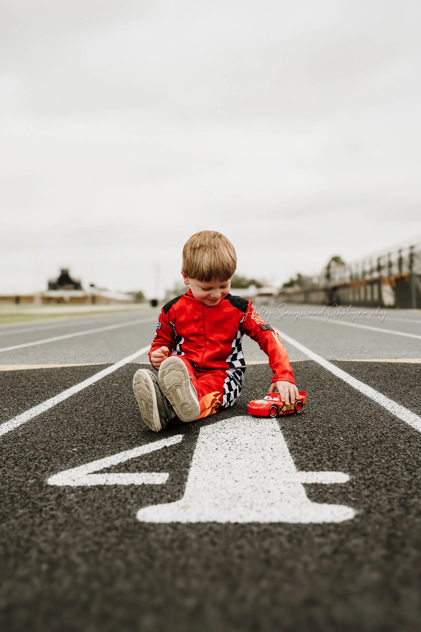 4-year-old boy celebrating his birthday with a race car themed photoshoot in Giddings Texas