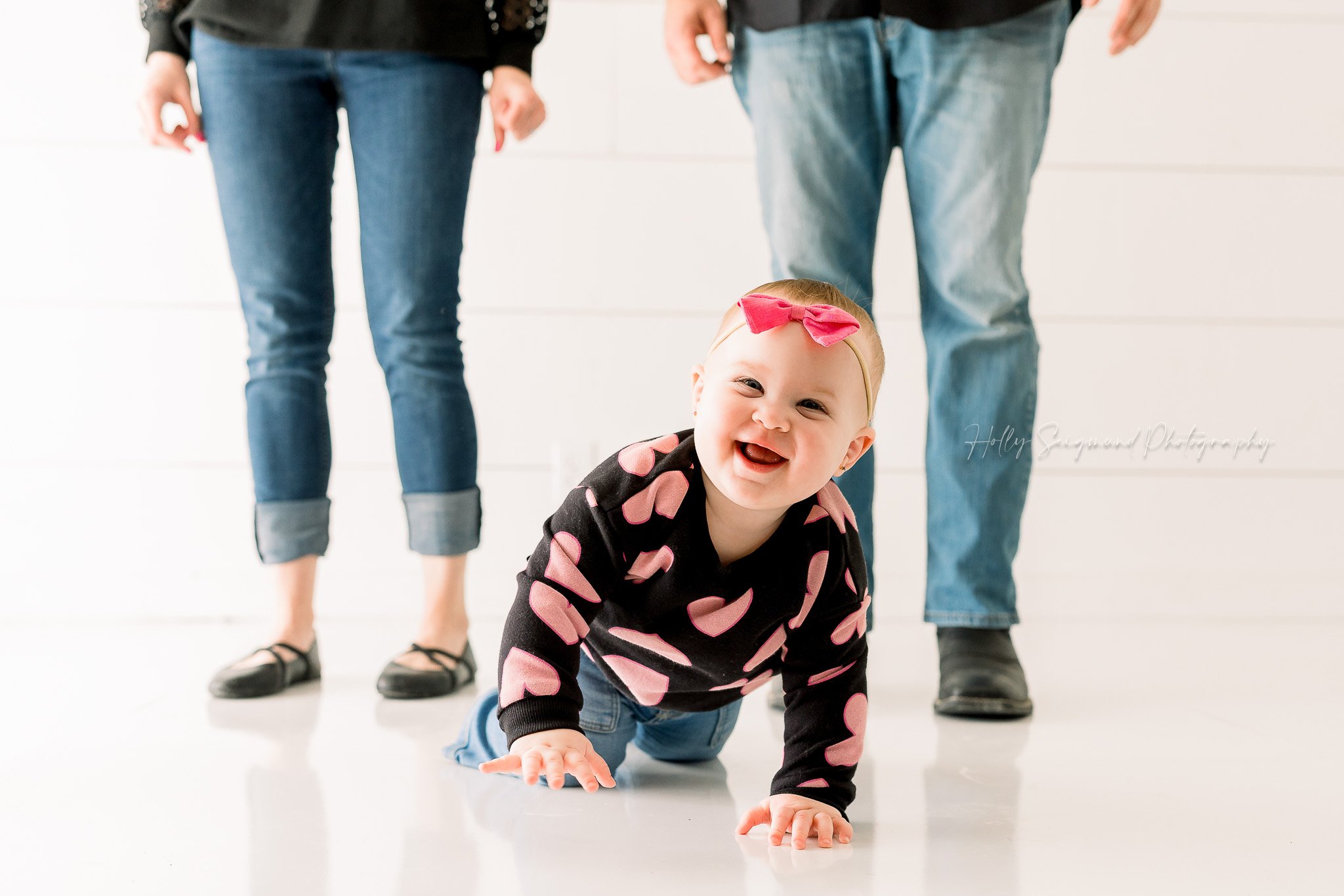 Baby girl crawling in an all white natural light studio in Lee County, Texas