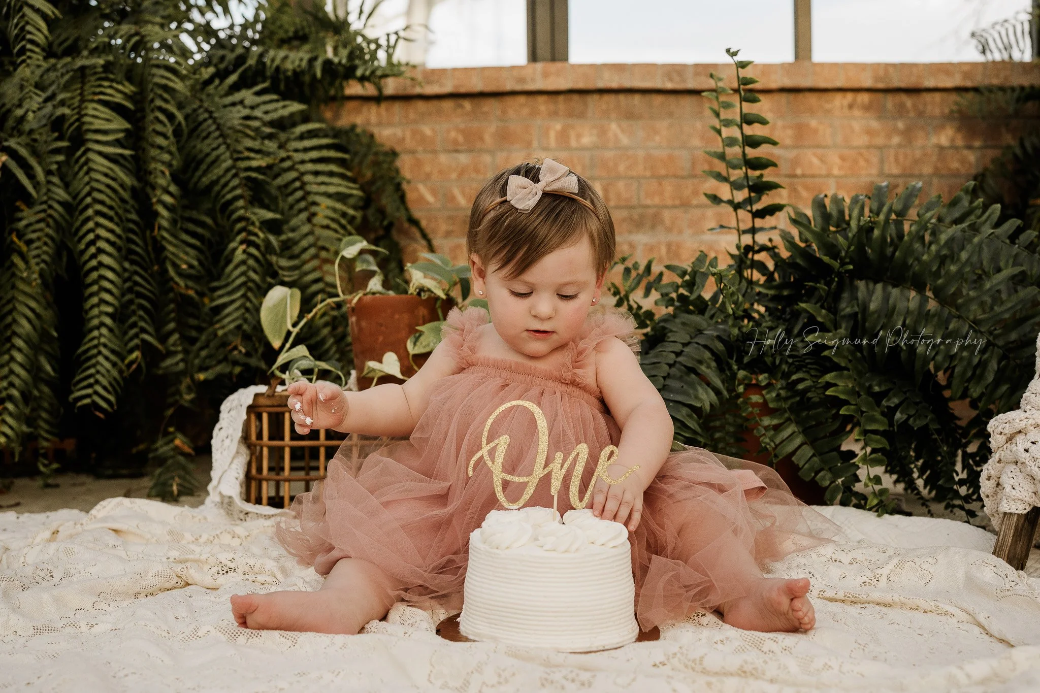 Boho first birthday cake smash with one-year-old girl in Central Texas